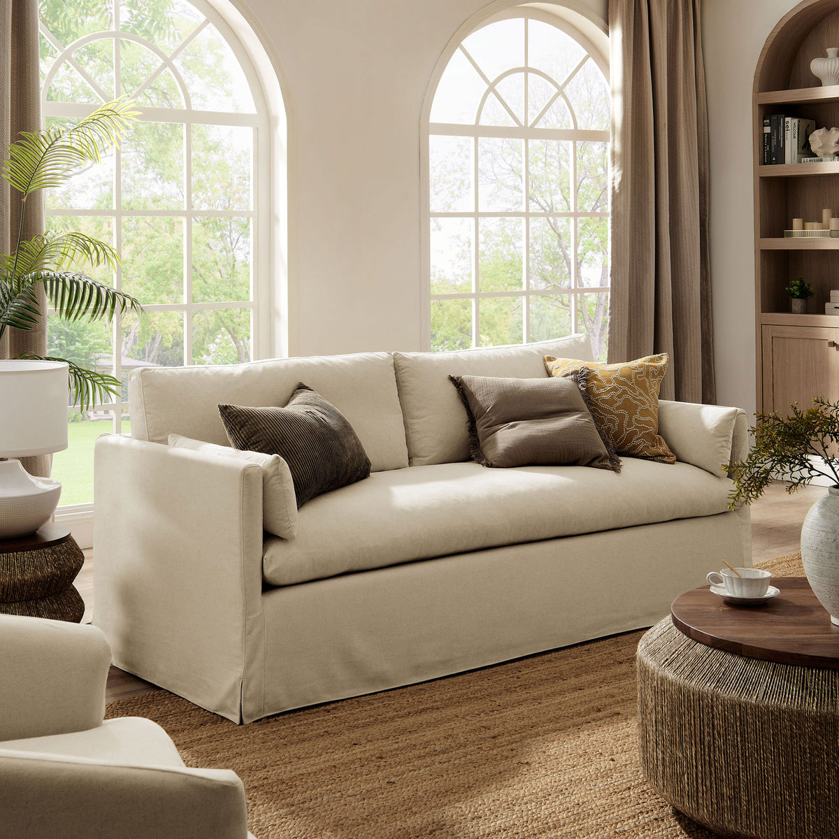 Wellfleet linen sofa paired with woven tables and rug for a relaxed, modern coastal look || EEI-7260-LIN || front_angle_room