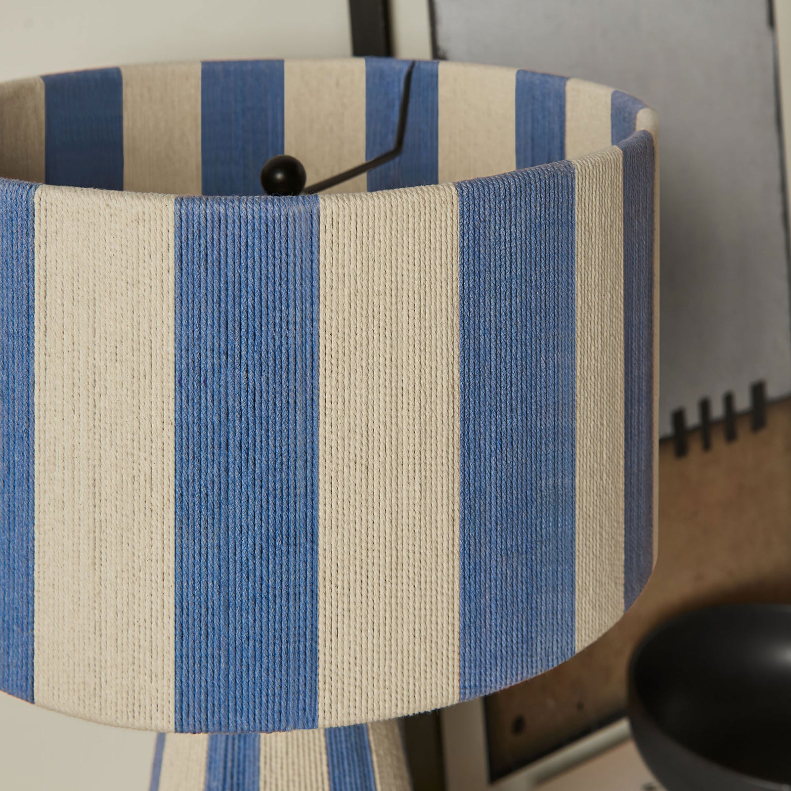 Capri blue striped shade adds texture and interest against a neutral wall and artwork. || EEI-7261-CBL || shade_room