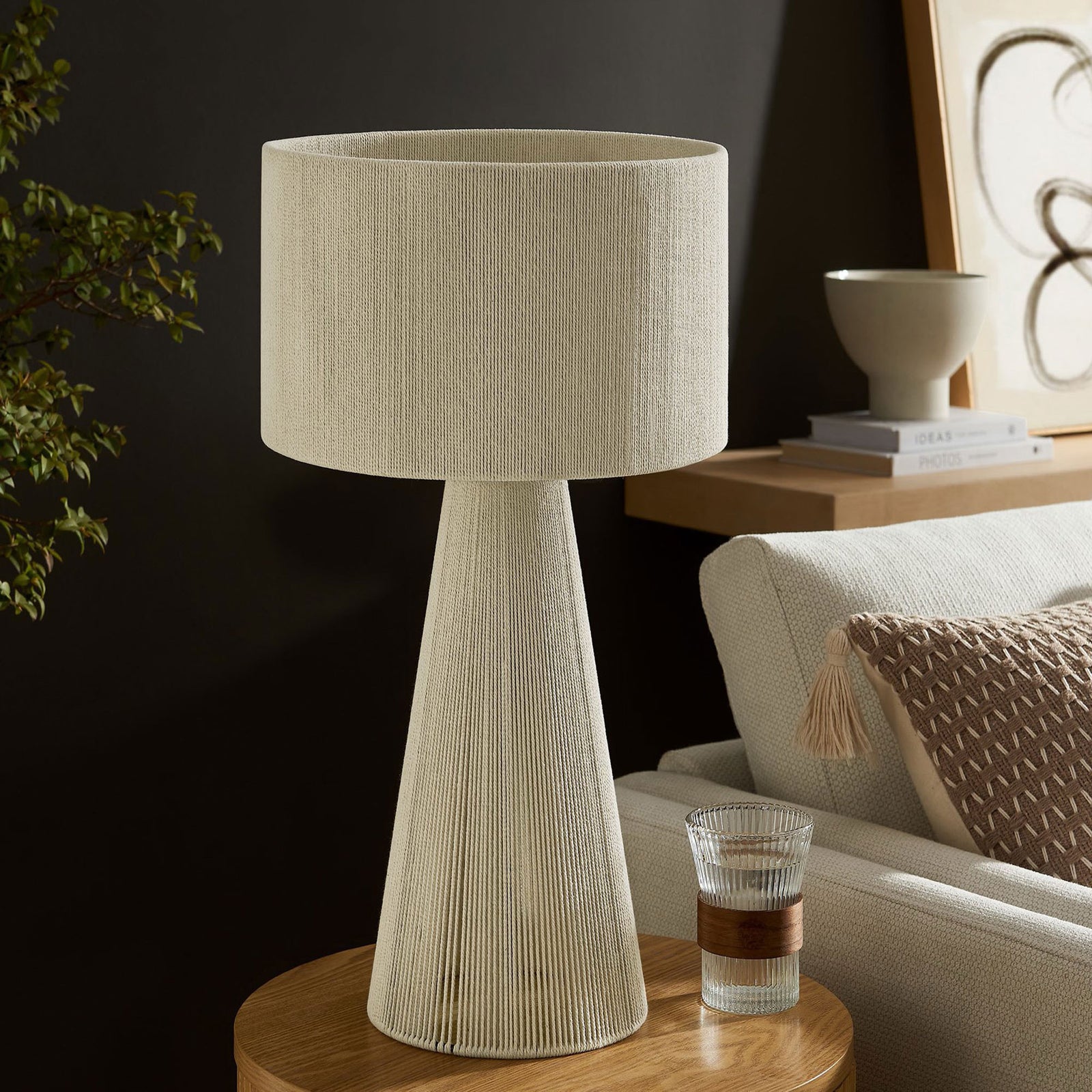 Natural cotton table lamp styling a side table with serene, understated elegance. || EEI-7262-NAT || front_angle_room