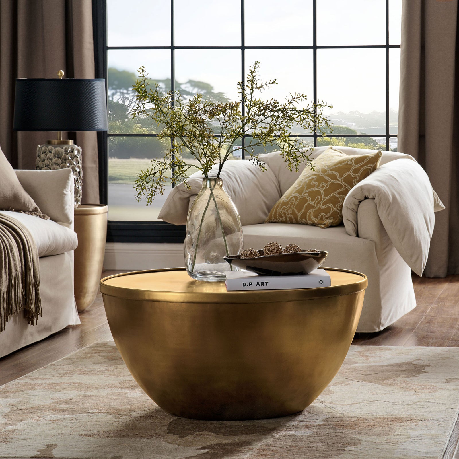 Elegant burnished brass centerpiece anchors the room with a warm glow and minimalist drum silhouette || EEI-7277-BBR || front_angle_room