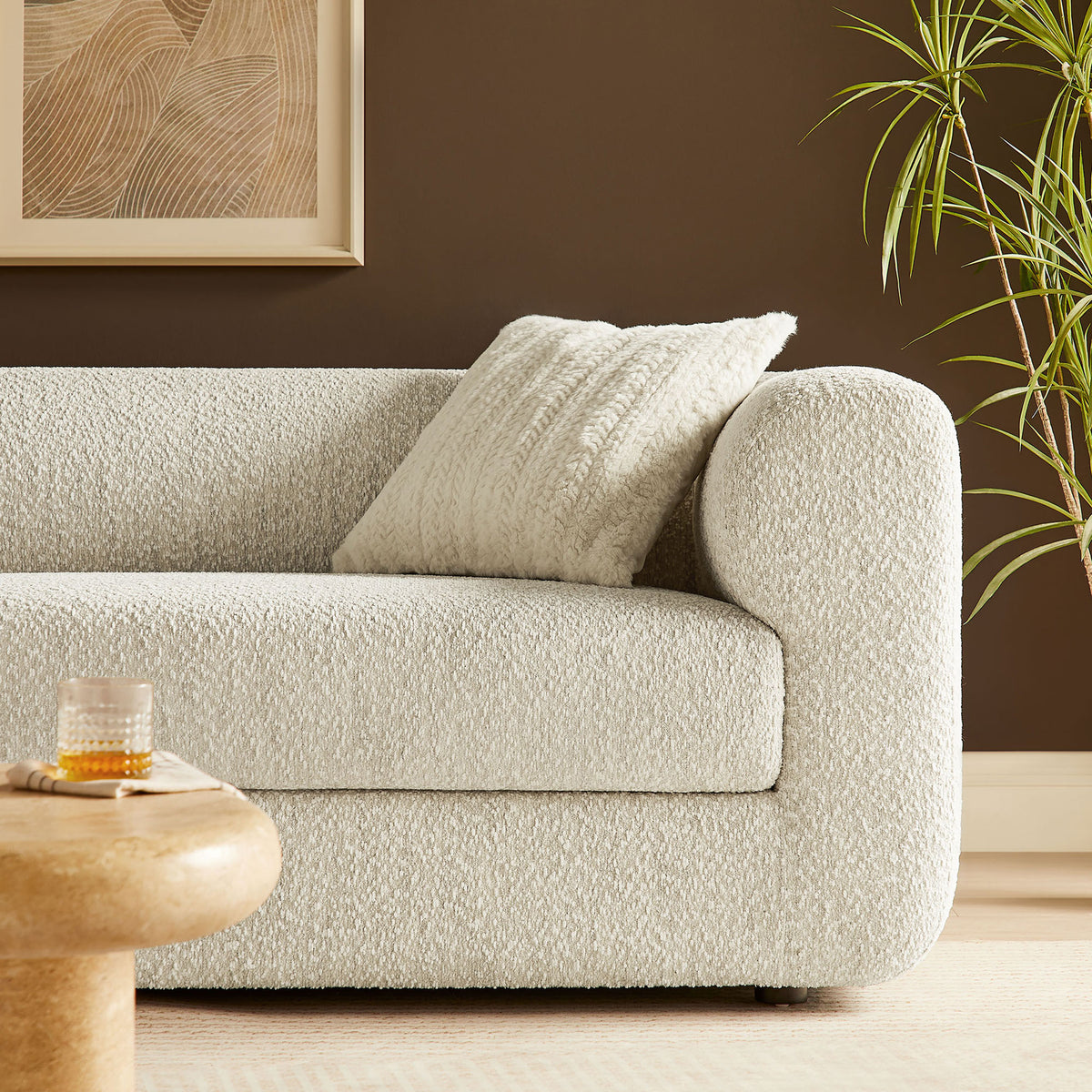 Pearl boucle sofa styled with textured pillow and warm wood accents for a cozy lounge nook || EEI-7280-PRL || detail_room