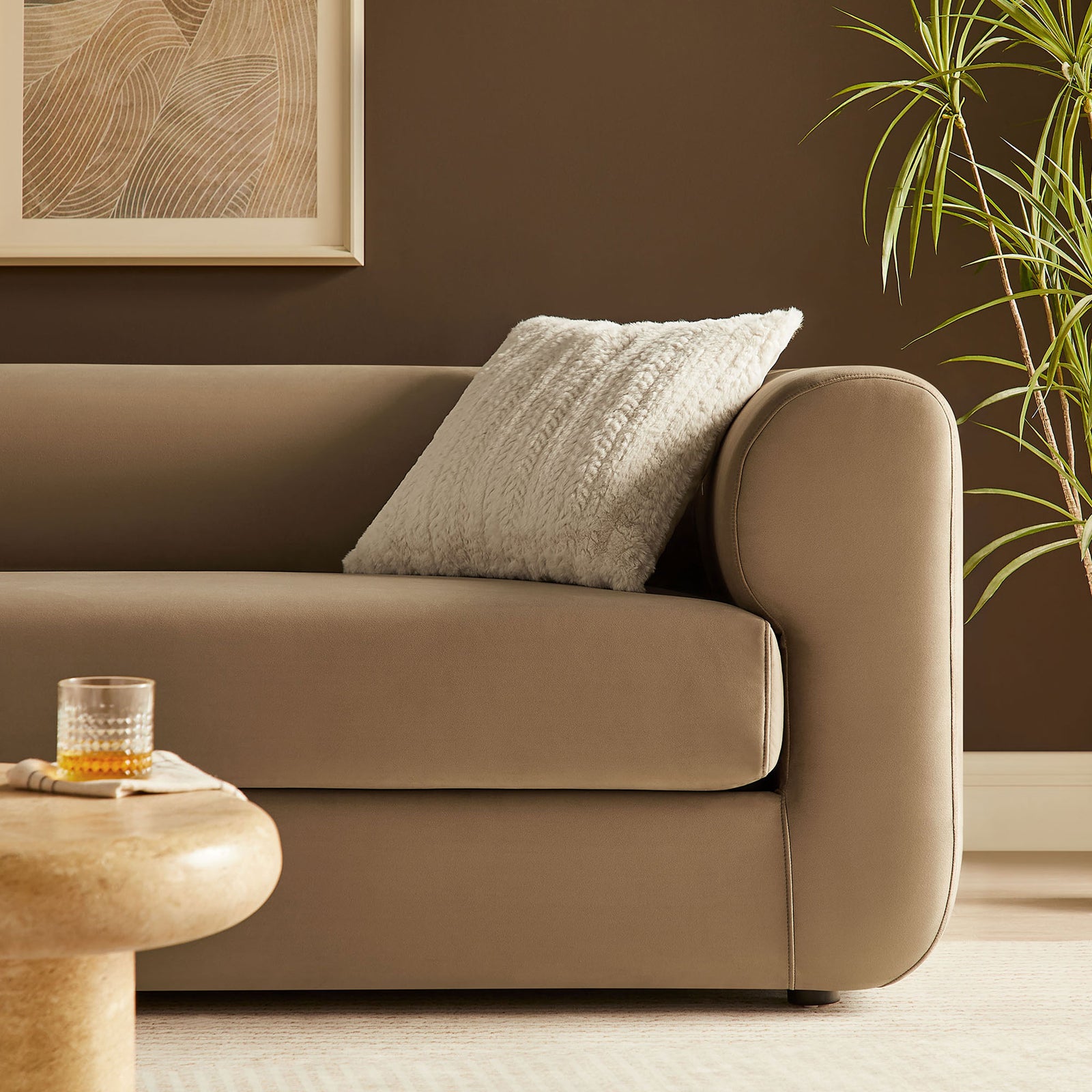 Warm taupe sofa pairs with a textured pillow and modern decor for a cozy, inviting living room look || EEI-7281-TAU || detail_room