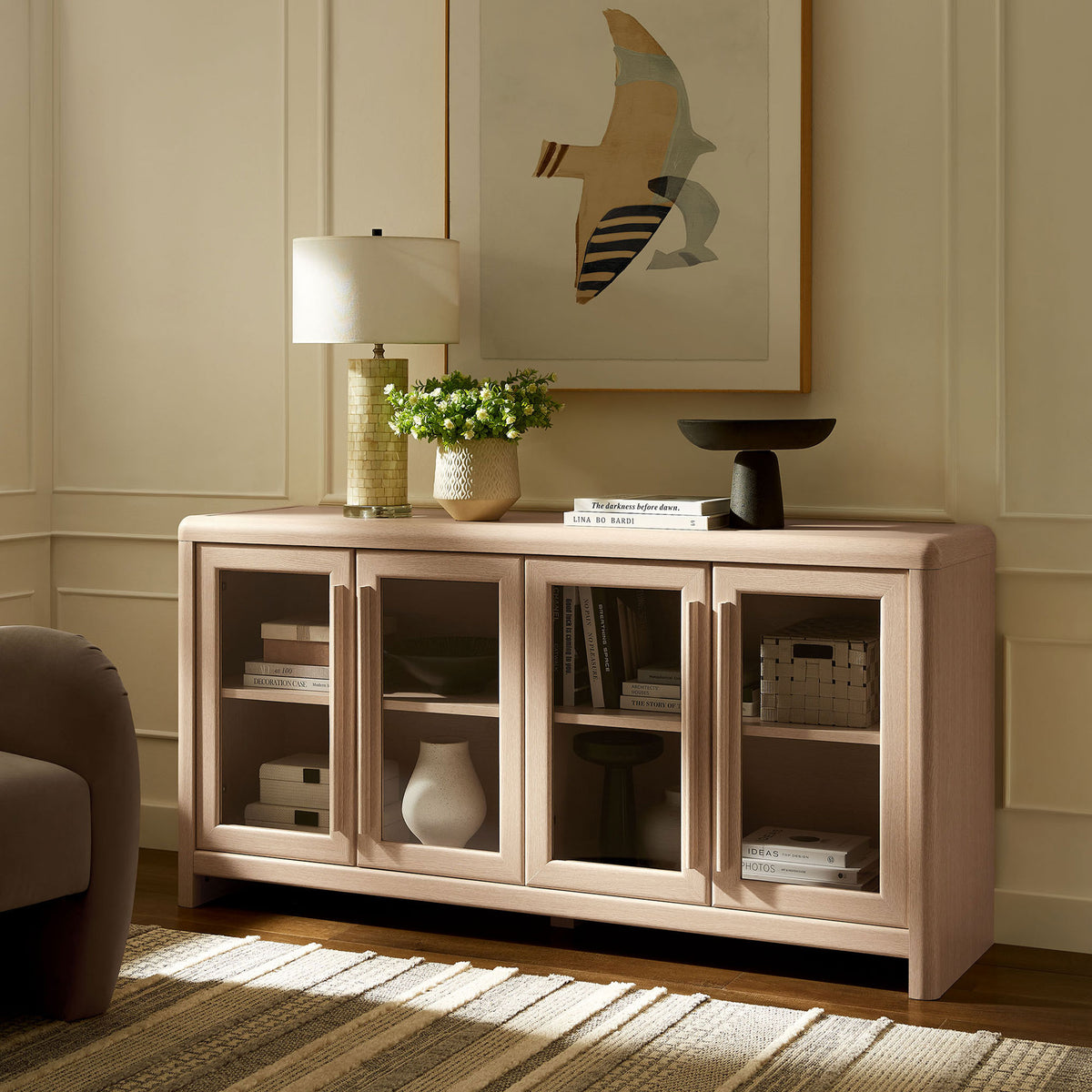 Evren ash sideboard cabinet styled in a modern living room with art, lighting, and greenery. || EEI-7287-ASH || front_angle_room