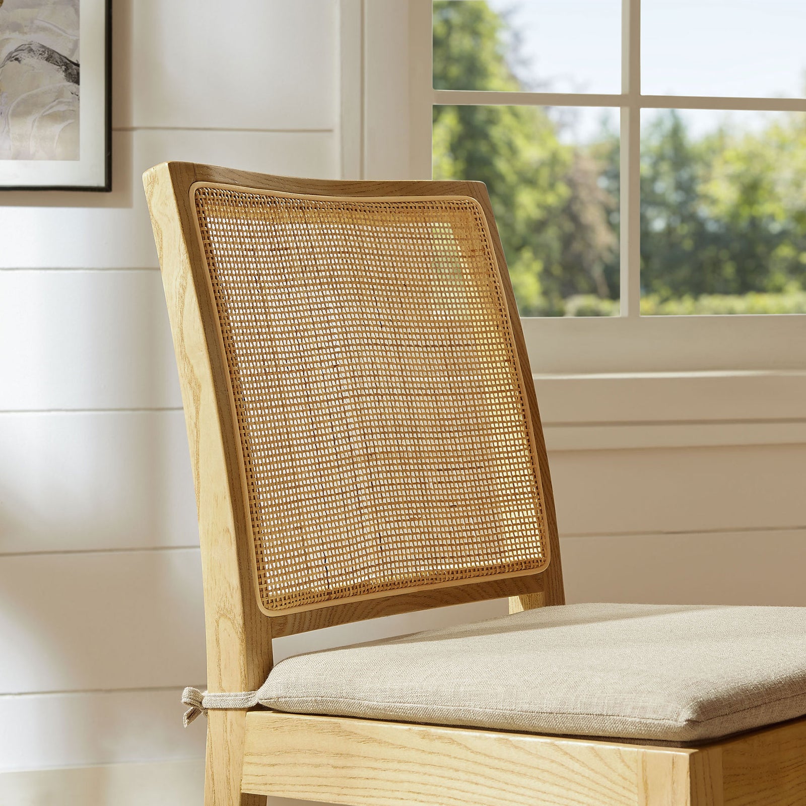 Rattan backrest framed in warm natural wood brings airy texture and warmth to a bright dining room setting || EEI-7288-NAT-BEI || detail_room