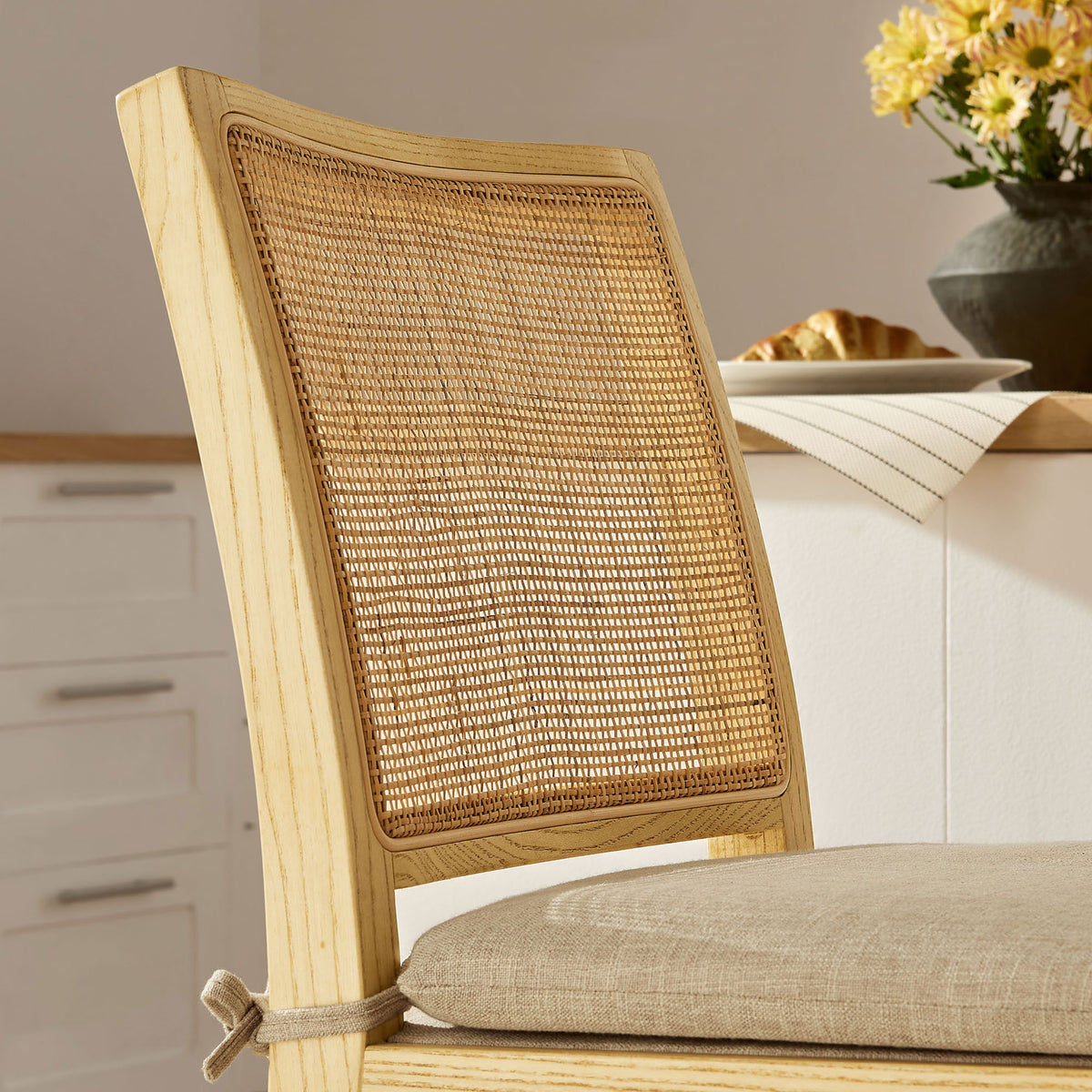 Textured rattan back pairs with a soft beige cushion to elevate casual seating. || EEI-7290-NAT-BEI || detail_room