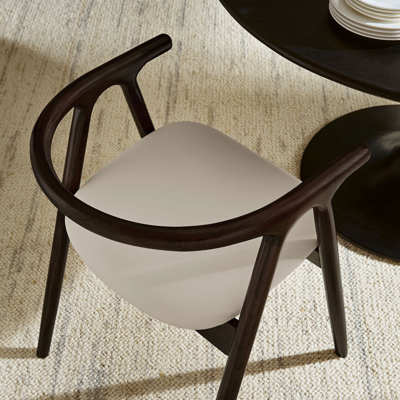 Henry dining chair in stone vegan leather pairs with round pedestal table over textured neutral rug || EEI-7291-STO || top_room
