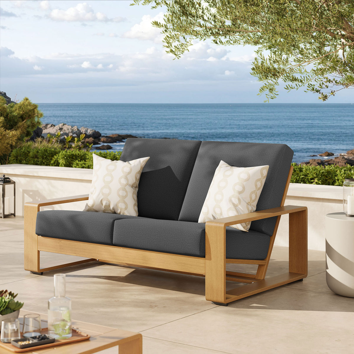 Charcoal and natural wood-look loveseat brings warm, modern comfort to an open-air patio || EEI-7297-CHA-NAT || front_angle_room