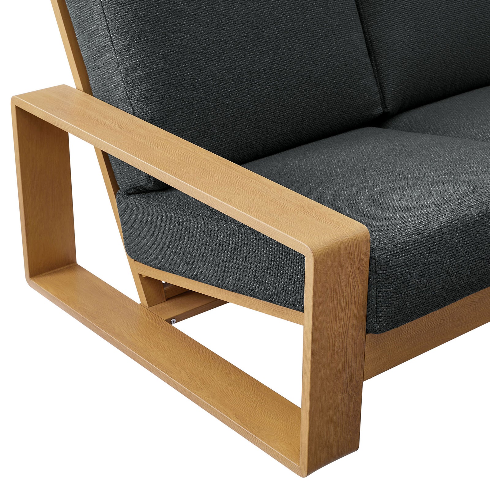 Natural wood-look arm and textured charcoal cushion emphasizing the sofa's clean, sculptural profile || EEI-7298-CHA-NAT || detail_studio