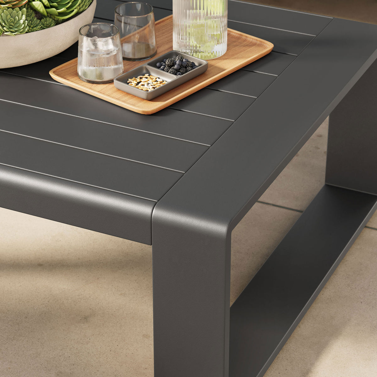 Gray outdoor coffee table styled with drinks and decor on a sunny patio || EEI-7303-GRY || detail_room