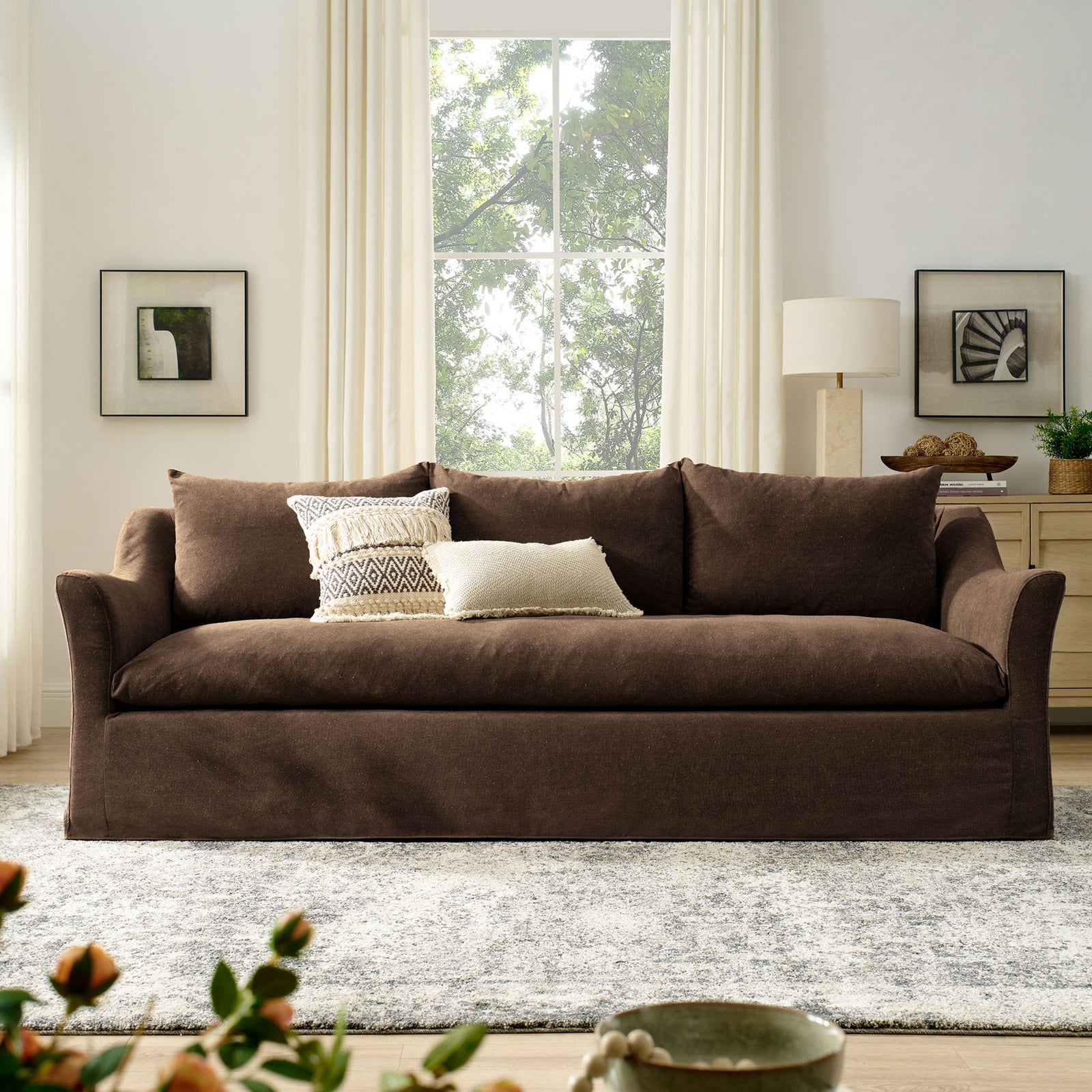 Front view of cocoa Somerset sofa centered in an airy living room with large window and neutral decor || EEI-7310-COA || front_room