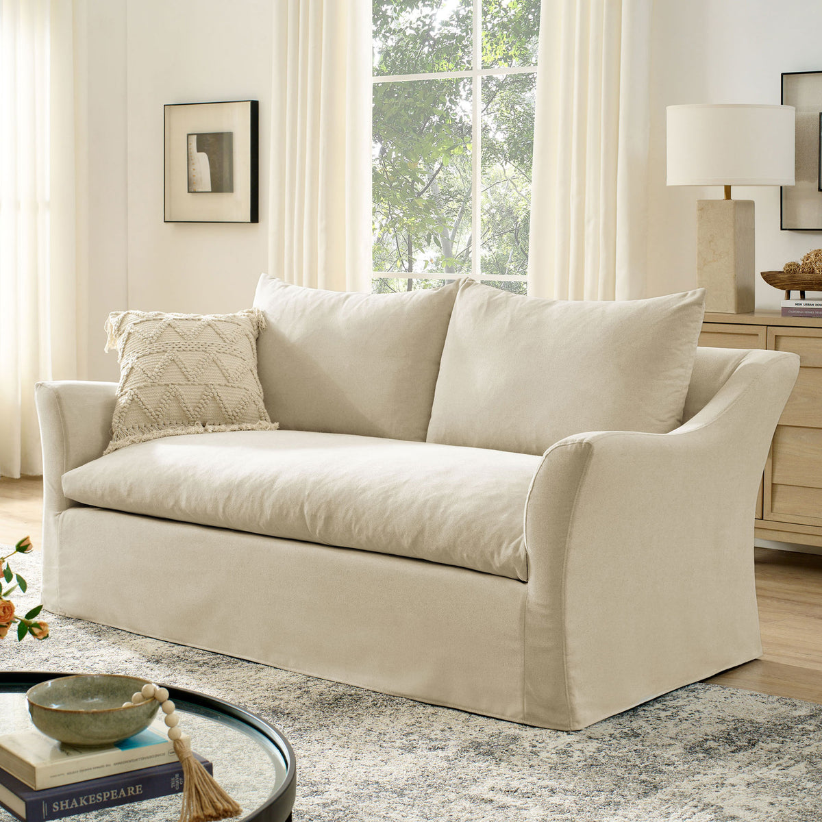 Linen slipcovered loveseat styled with rug, accent pillow, and light wood furniture || EEI-7311-LIN || front_angle_room