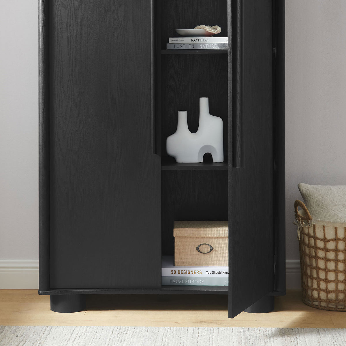 Styled Bellamy black cabinet with open shelves displaying decor accents, books, and storage box || EEI-7313-BLK || storage_open_room