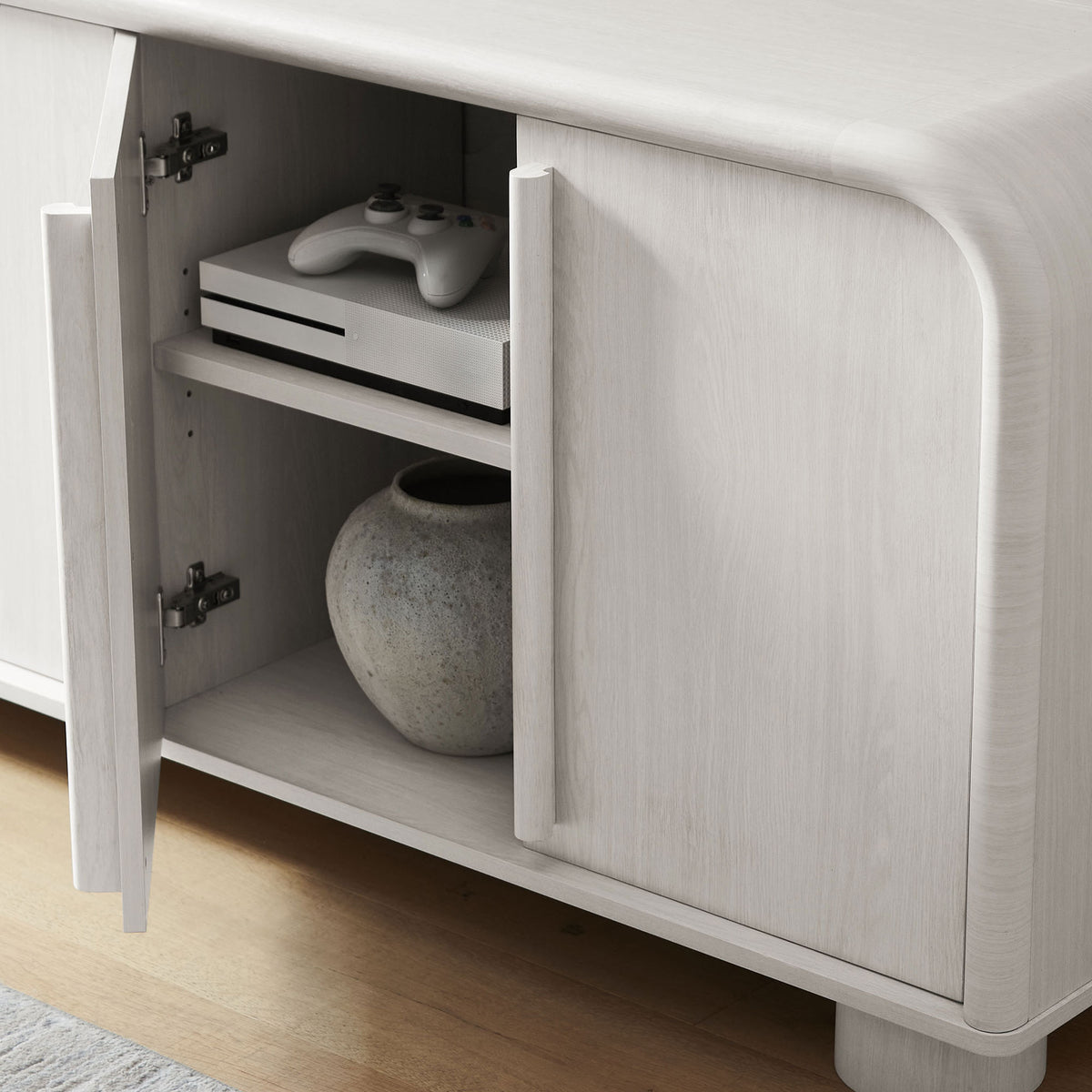 Open cabinet door in a styled room vignette showing adjustable shelf with media console and decorative vase || EEI-7315-ASH || storage_open_room