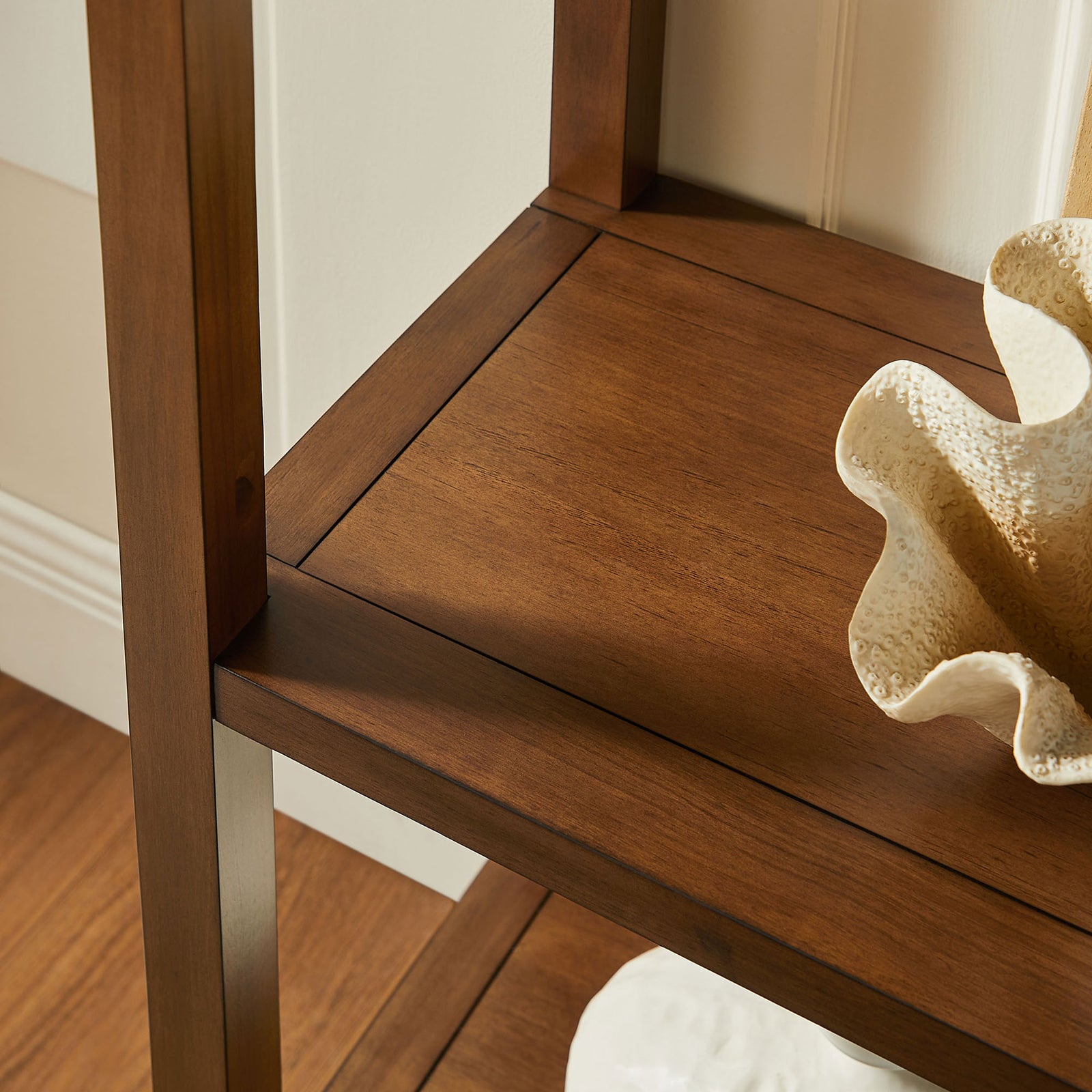 Smooth shelf corner detail with rich walnut tone complements decor pieces || EEI-7318-WAL || detail_room