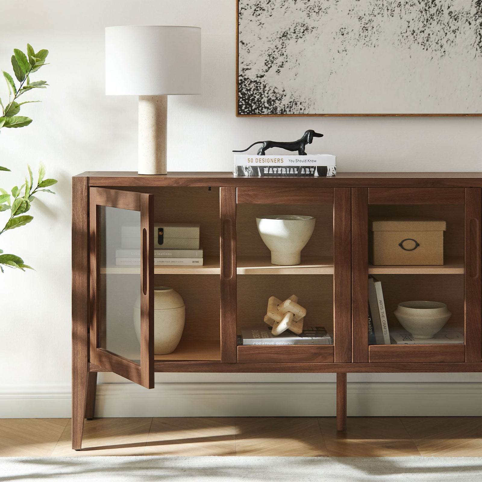 Styled sideboard shows open glass door with decor arranged on the spacious interior shelves || EEI-7319-WAL-ASH || storage_open_room