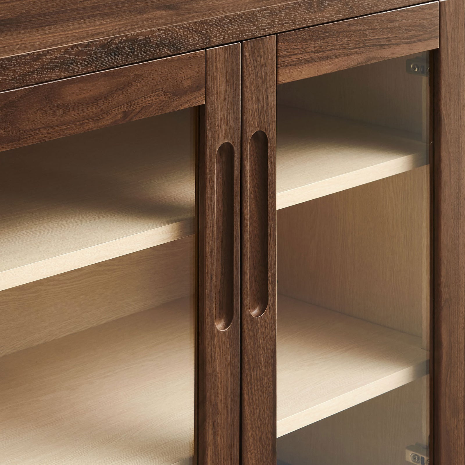 Finger-pull cutout handles and framed glass doors on the walnut Nell accent cabinet for a refined modern touch || EEI-7321-WAL-ASH || handle_studio