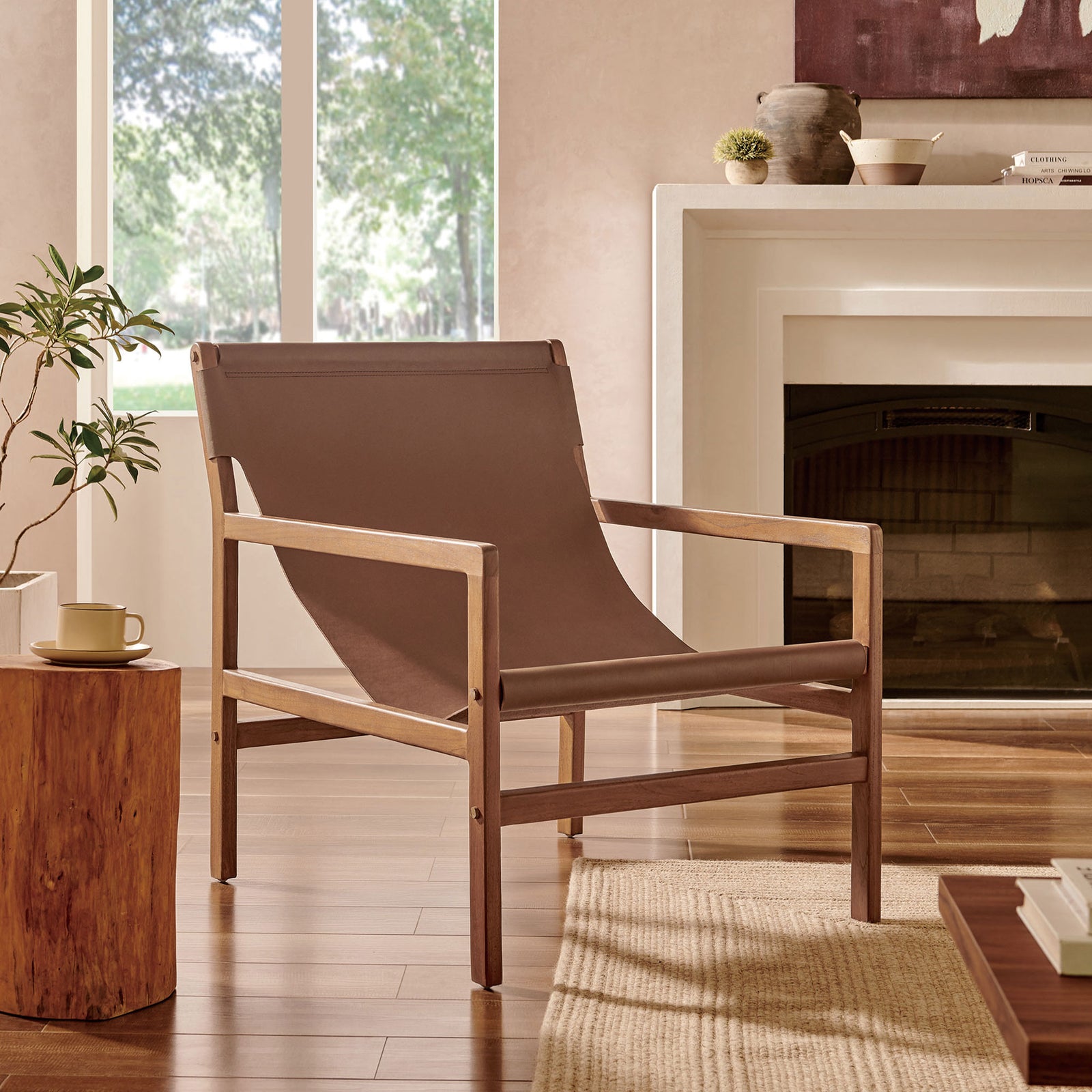 Relaxed sling silhouette adds inviting style to living spaces with timeless teak and leather || EEI-7324-NUT || front_angle_room