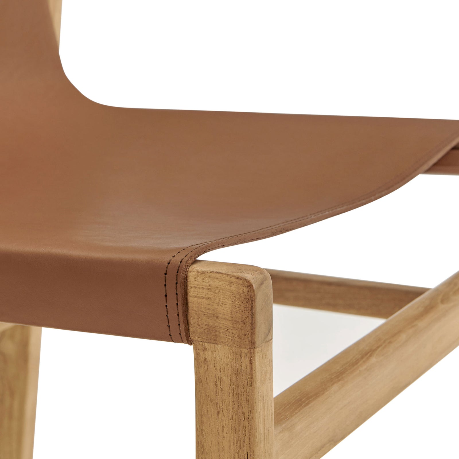 Smooth chestnut leather seat draped over solid teak frame with neat topstitching at the front edge || EEI-7326-CSN || detail_studio