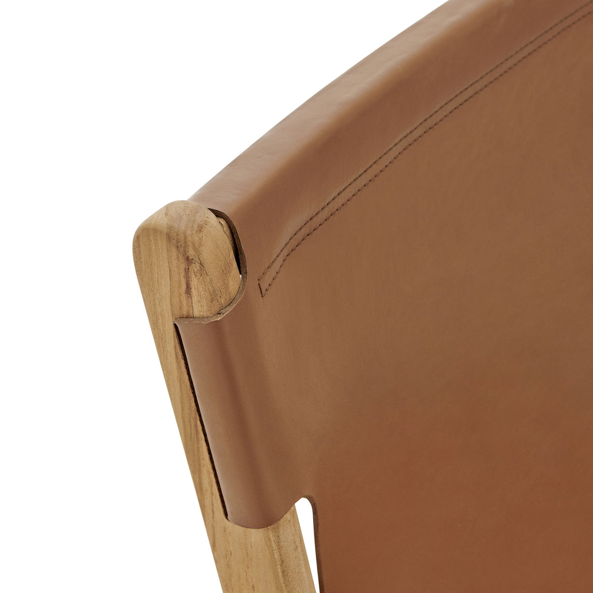Curved teak backrest wrapped in chestnut leather, showcasing tailored stitching and artisanal joinery || EEI-7326-CSN || detail_studio