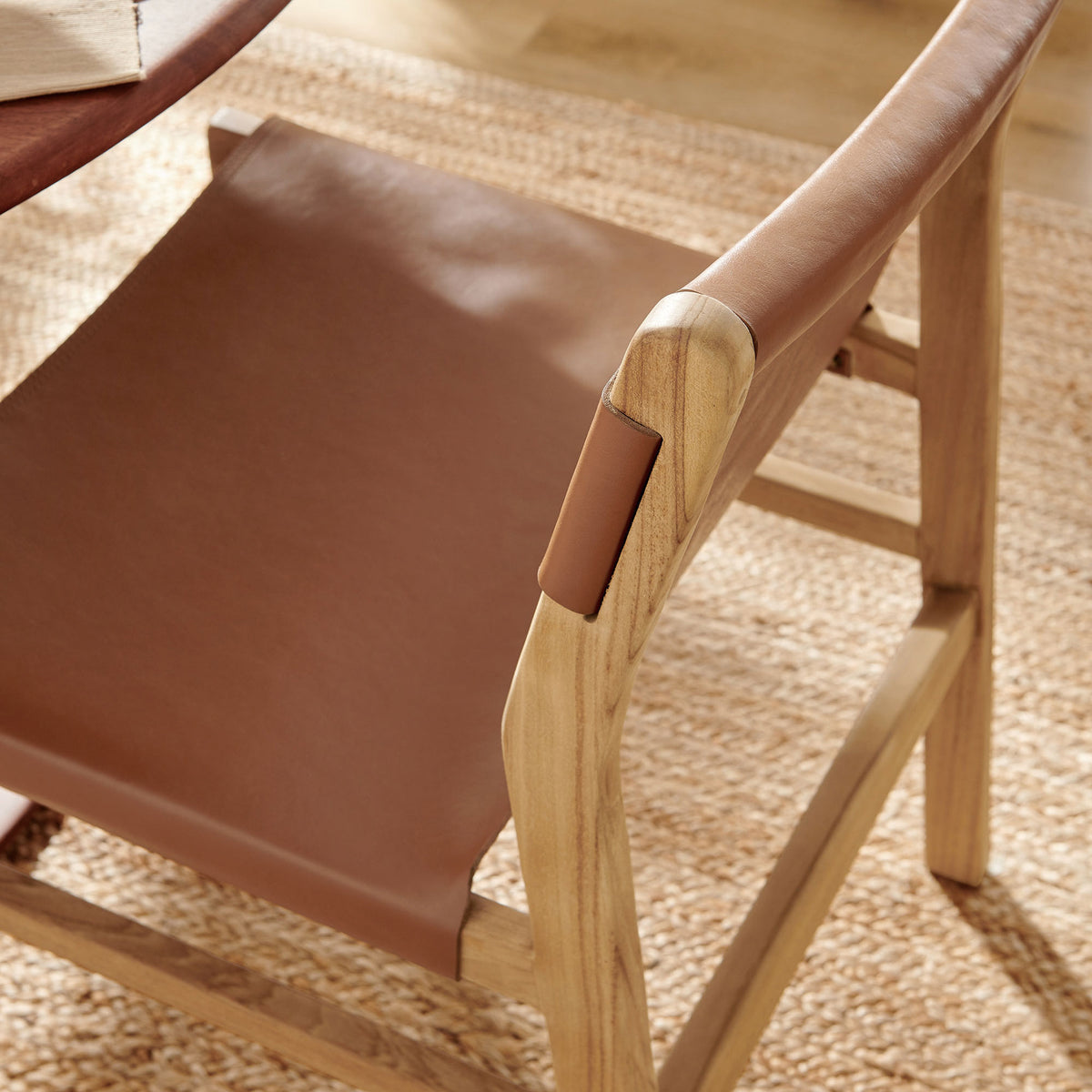 Leather dining chair styled at a round table, adding warmth and texture to a light-filled dining room || EEI-7326-CSN || detail_room