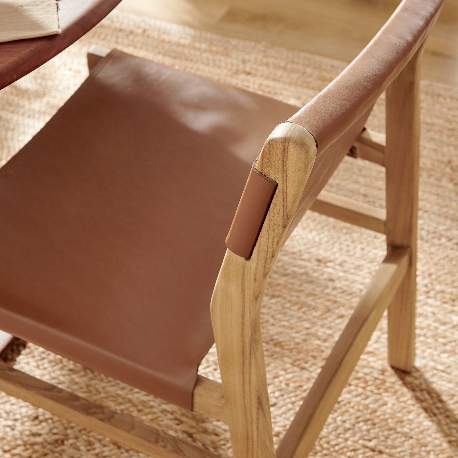 Leather dining chair styled at a round table, adding warmth and texture to a light-filled dining room || EEI-7326-CSN || detail_room