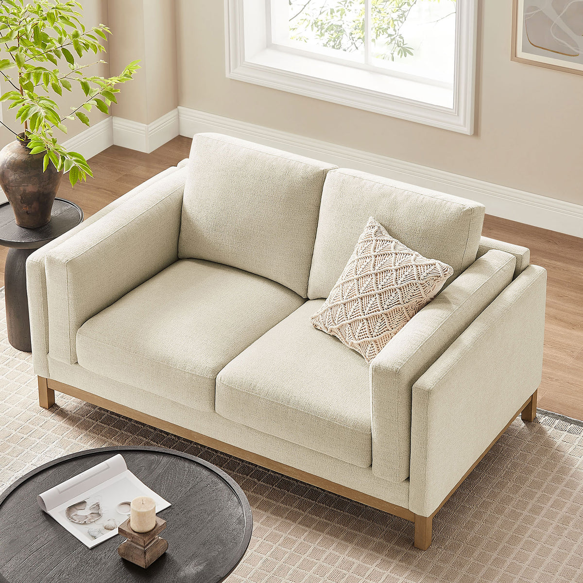Wide, deep cushions and slim arms showcase the loveseat's spacious, lounge-ready seating. || EEI-7328-IVO || top_angle_room