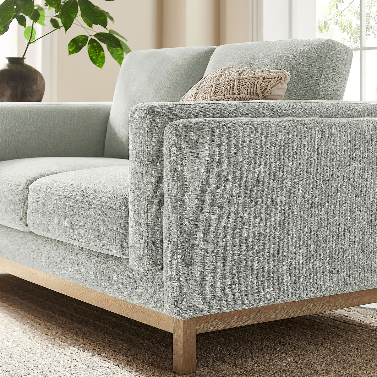 Mist loveseat arm detail in a cozy living space with greenery, window light, and boho accent pillow || EEI-7328-MST || detail_room