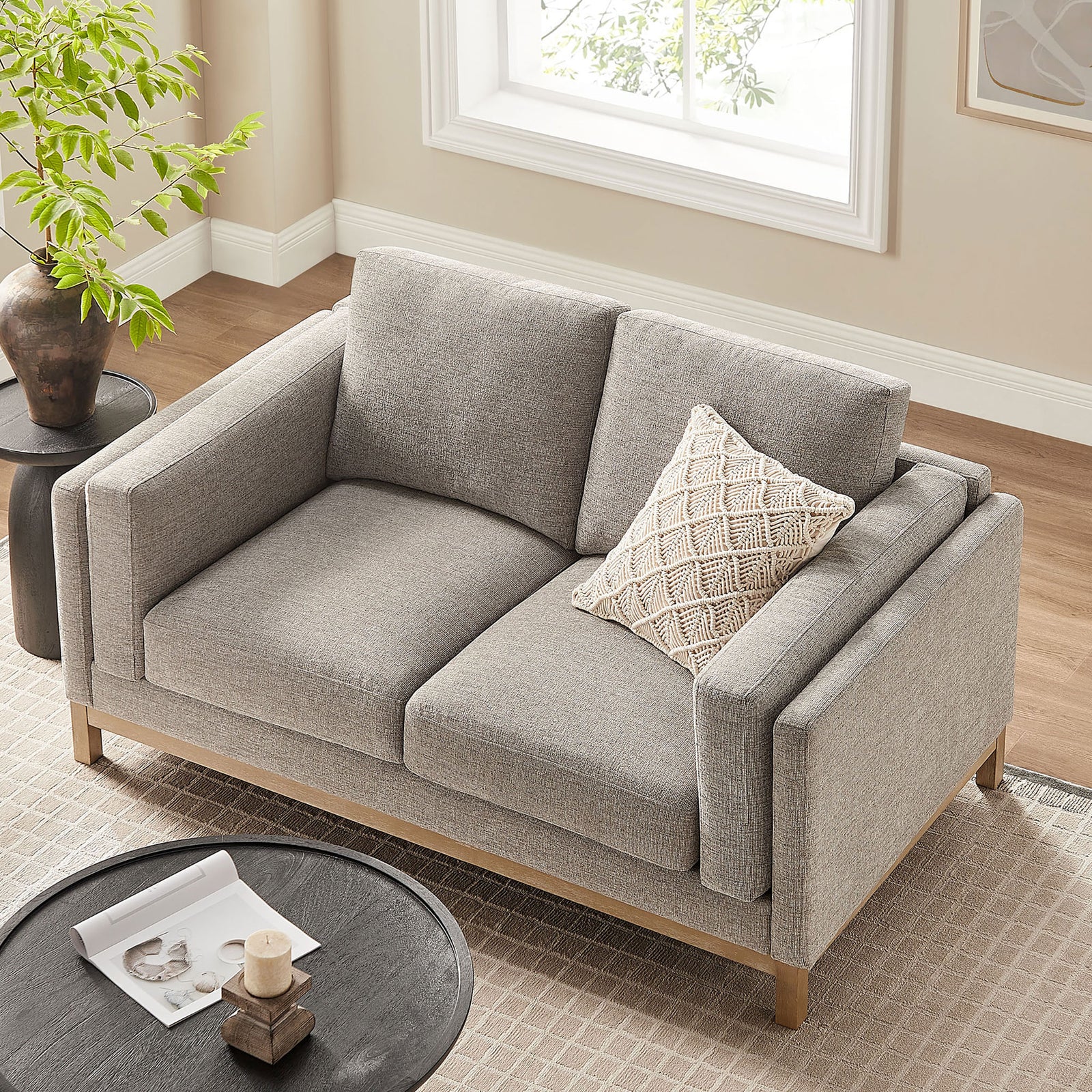 Deep seat loveseat with generous cushions and slim wood base fits perfectly into a warm, sunlit room. || EEI-7328-PEW || top_angle_room