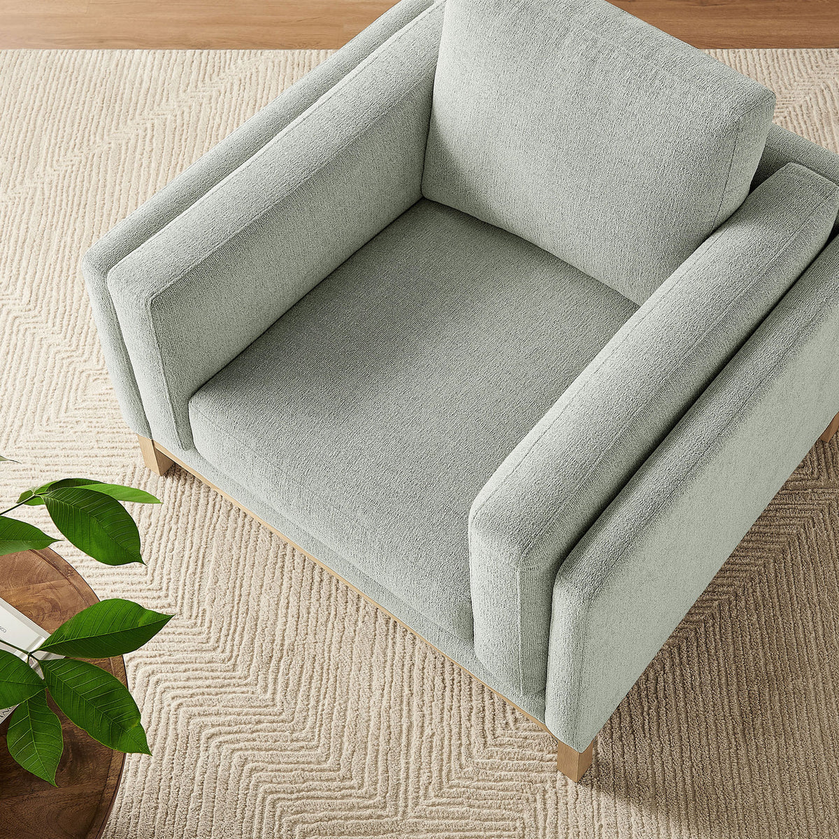 Inviting lounge seat with thick cushions and tailored track arms atop a natural wood base || EEI-7329-MST || top_angle_room