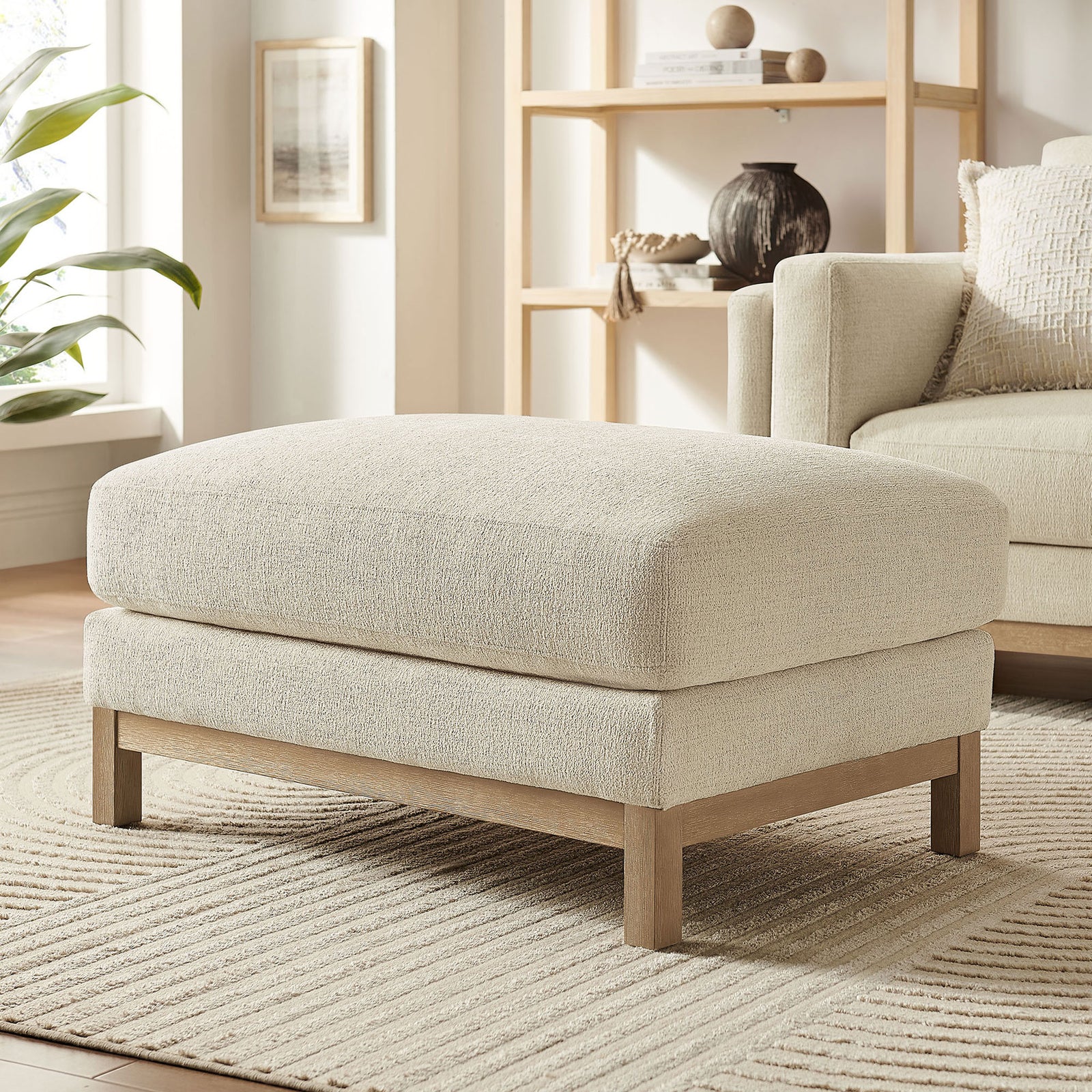 Ivory ottoman in bright living room paired with matching sofa and neutral decor || EEI-7330-IVO || front_angle_room
