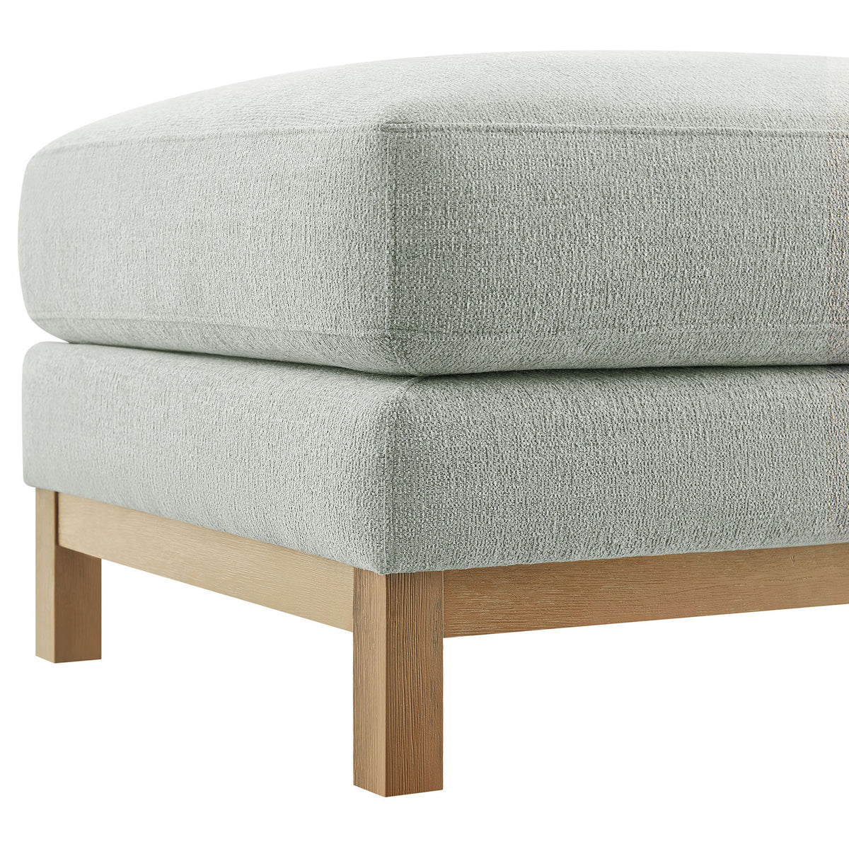Corner of mist chenille ottoman showcasing tailored seams and smooth wood leg || EEI-7330-MST || detail_studio