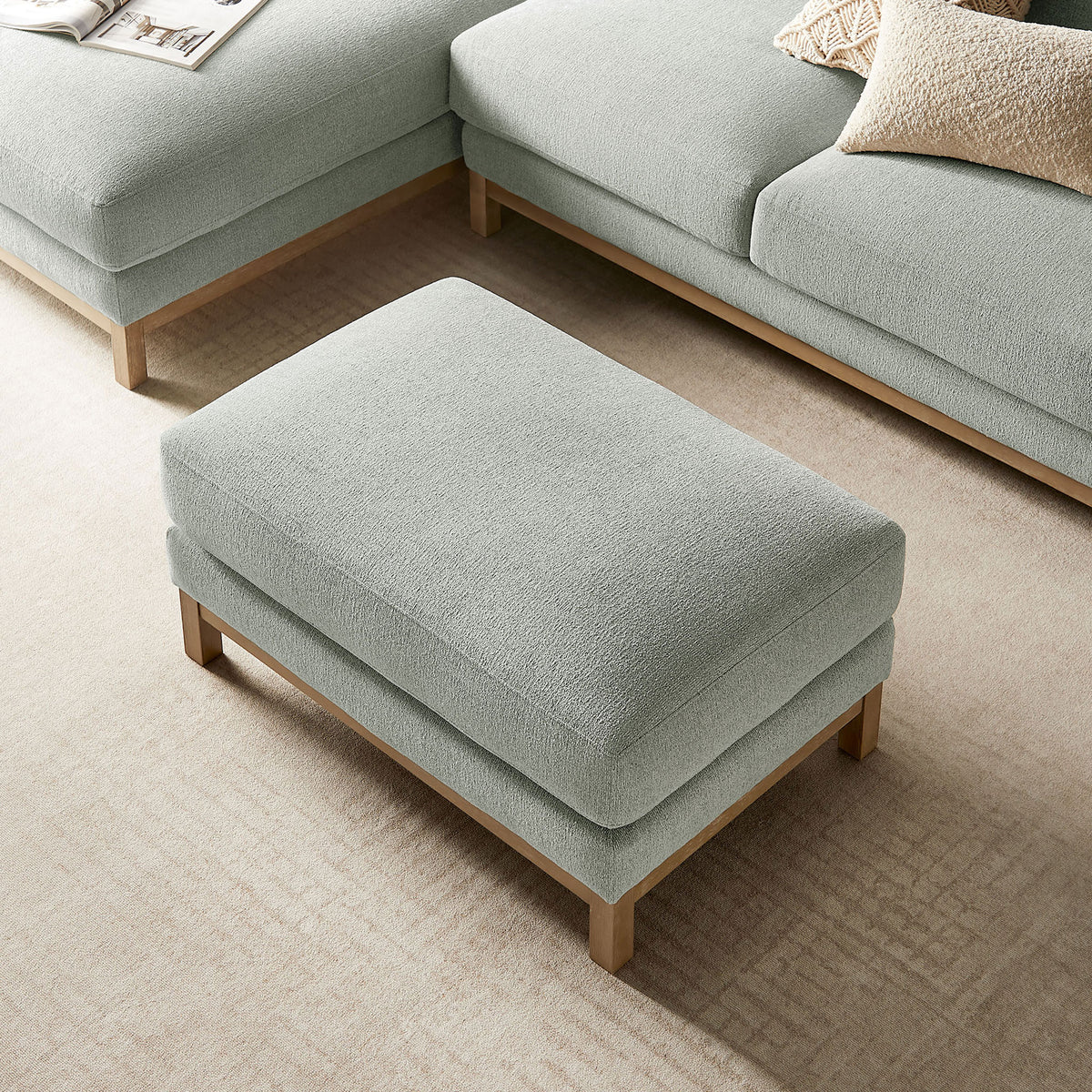 Rectangular mist ottoman centered between modular seating, offering a soft landing in the living room || EEI-7330-MST || top_angle_room
