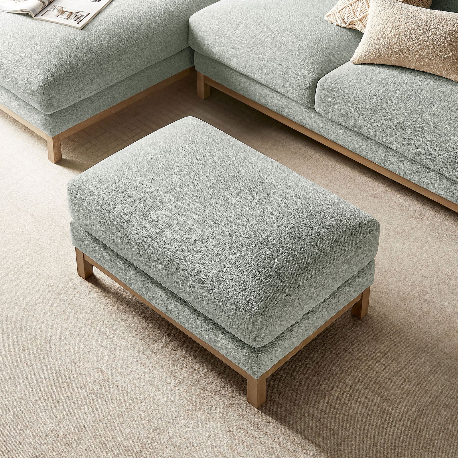 Rectangular mist ottoman centered between modular seating, offering a soft landing in the living room || EEI-7330-MST || top_angle_room