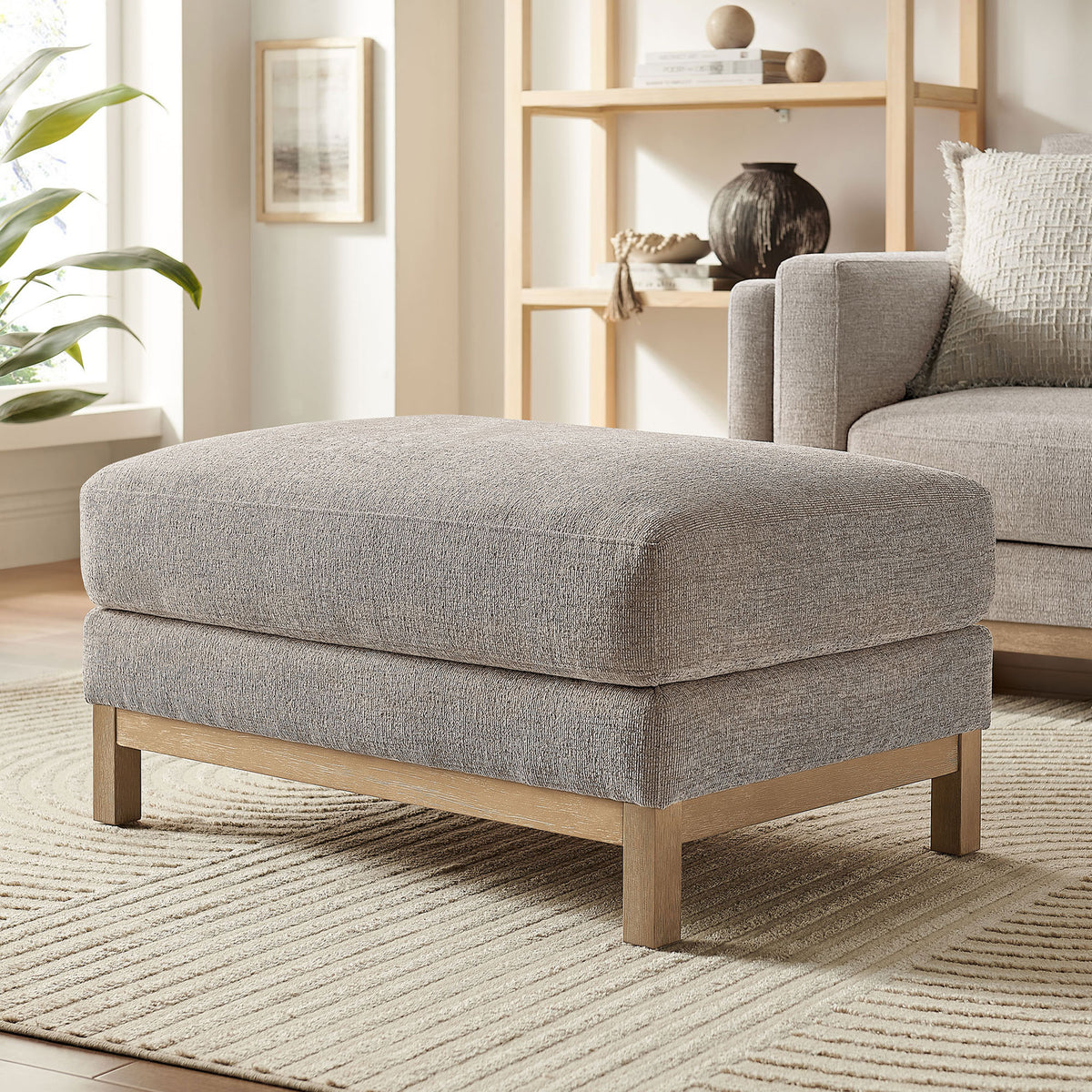 Roscoe pewter ottoman adds cushioned comfort and warm wood texture to a bright, modern living room. || EEI-7330-PEW || front_angle_room