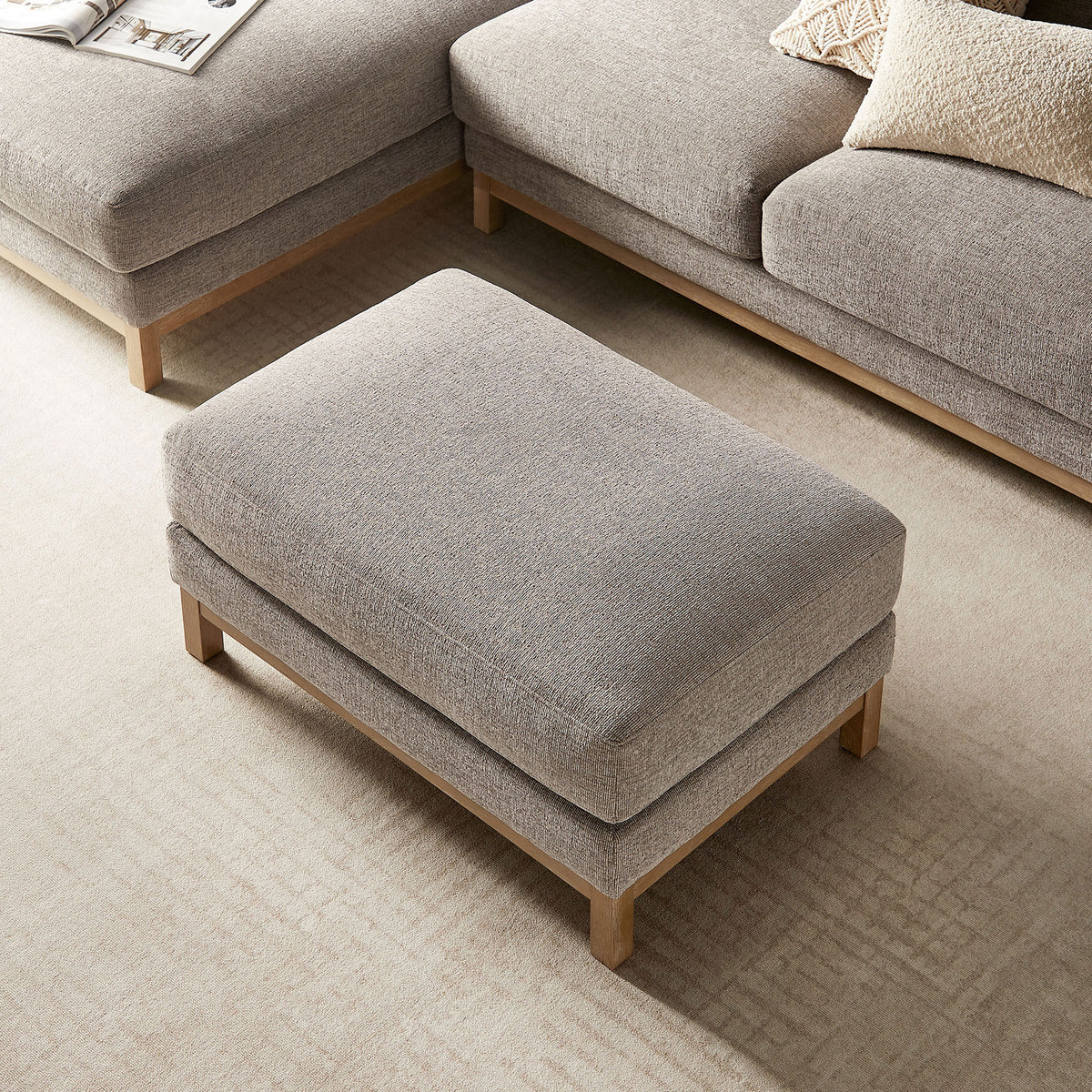 Rectangular Roscoe ottoman anchors the seating area, offering a plush surface between matching sofas. || EEI-7330-PEW || top_angle_room