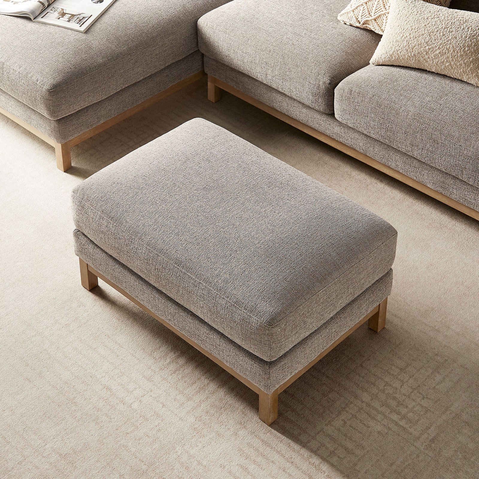 Rectangular Roscoe ottoman anchors the seating area, offering a plush surface between matching sofas. || EEI-7330-PEW || top_angle_room