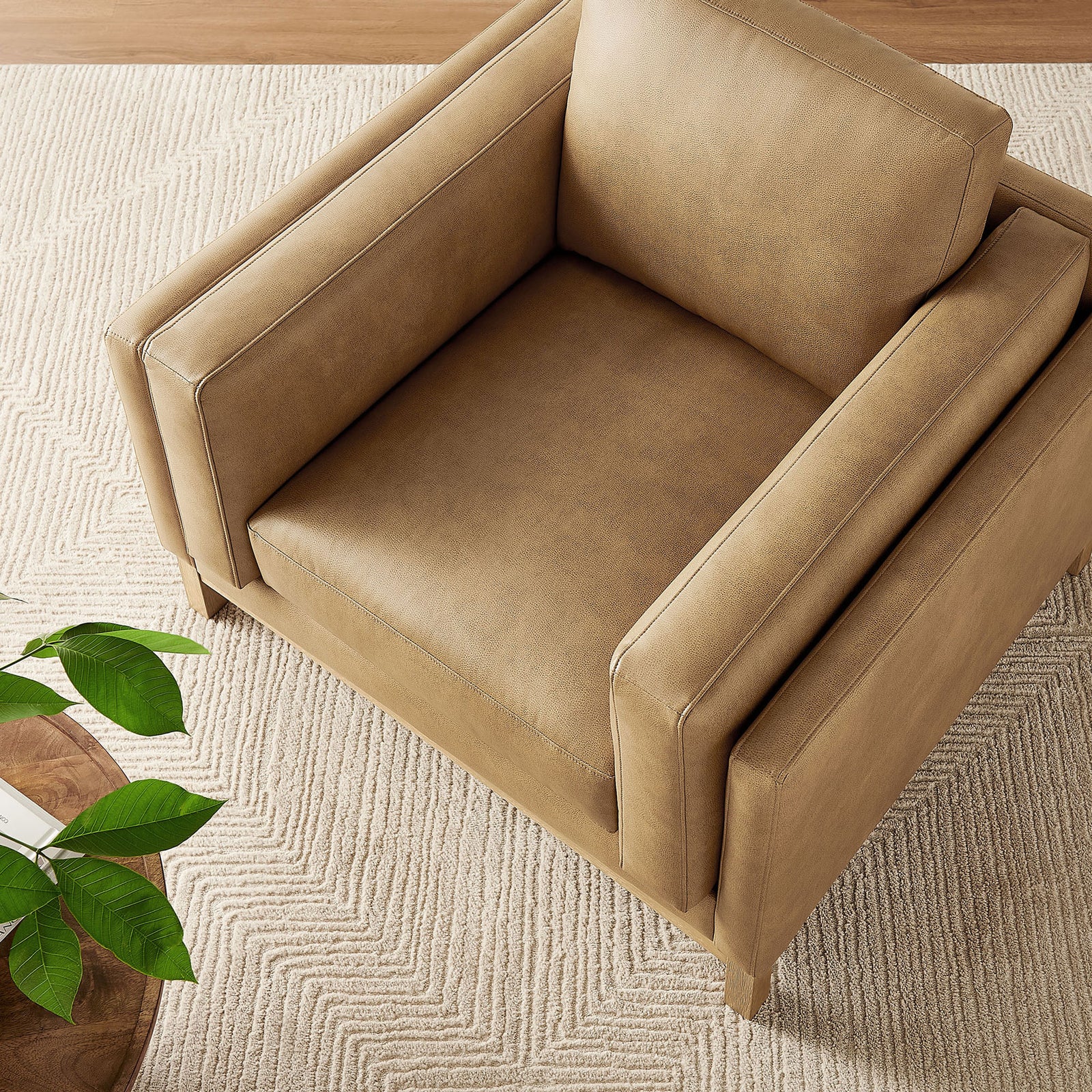 Warm toast tone pairs with a weathered wood base for a modern, low-profile accent chair. || EEI-7337-TST || top_angle_room