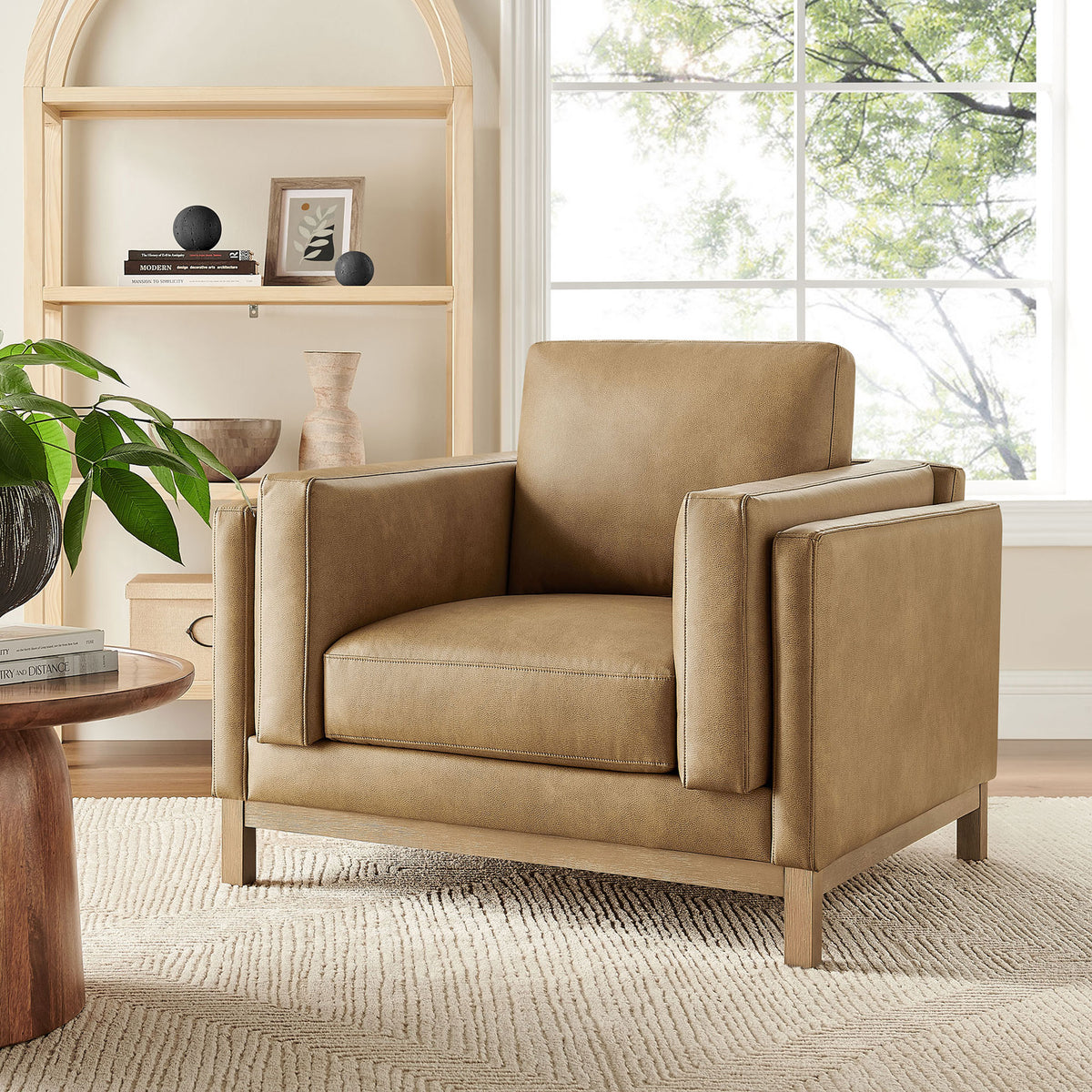 Vegan leather armchair elevates living spaces with clean lines, deep seat, and natural wood legs. || EEI-7337-TST || front_angle_room