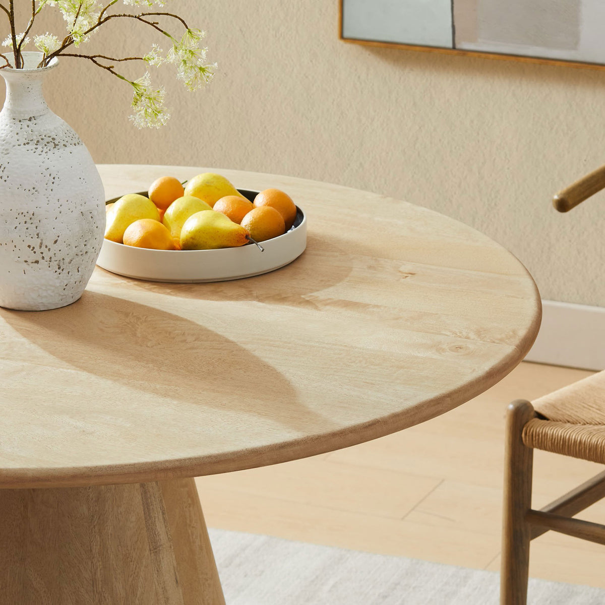 Styled tabletop with fruit bowl and ceramic vase to showcase the table's warm natural wood finish. || EEI-7343-NAT || detail_room