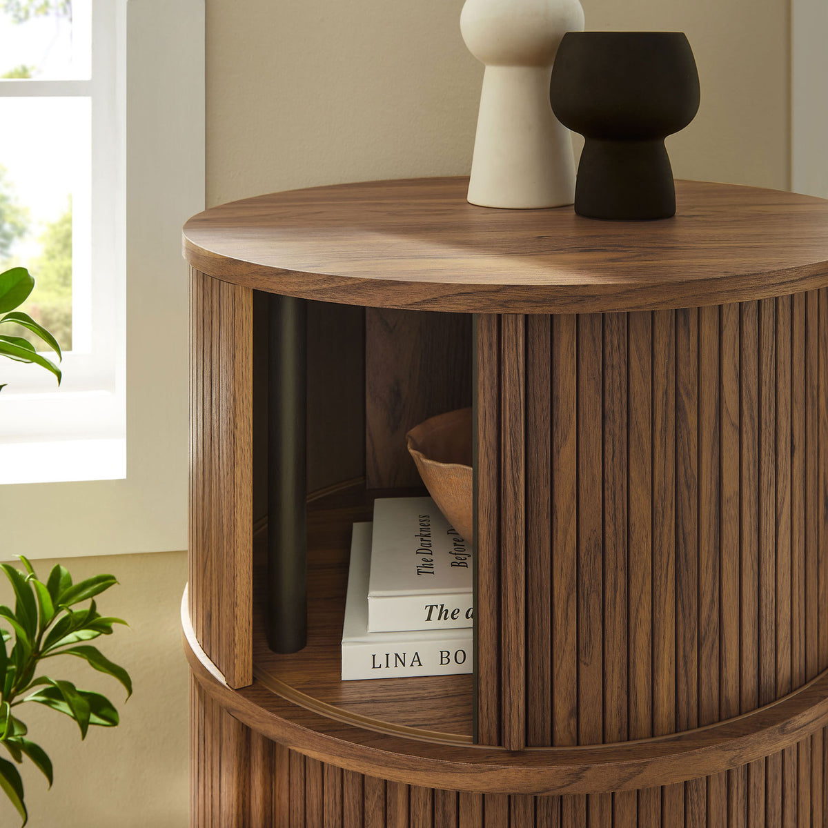 Walnut tambour storage table styled with books and ceramics, showing easy access to the open compartment || EEI-7344-WAL || storage_open_room