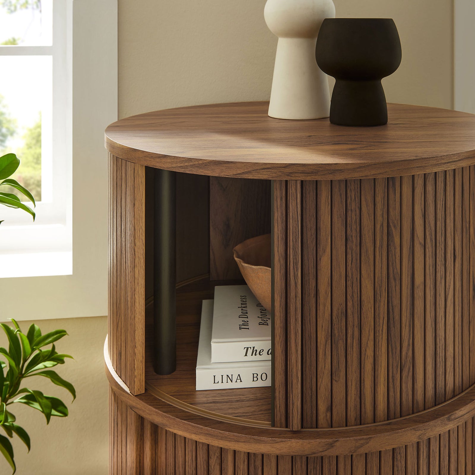 Walnut tambour storage table styled with books and ceramics, showing easy access to the open compartment || EEI-7344-WAL || storage_open_room
