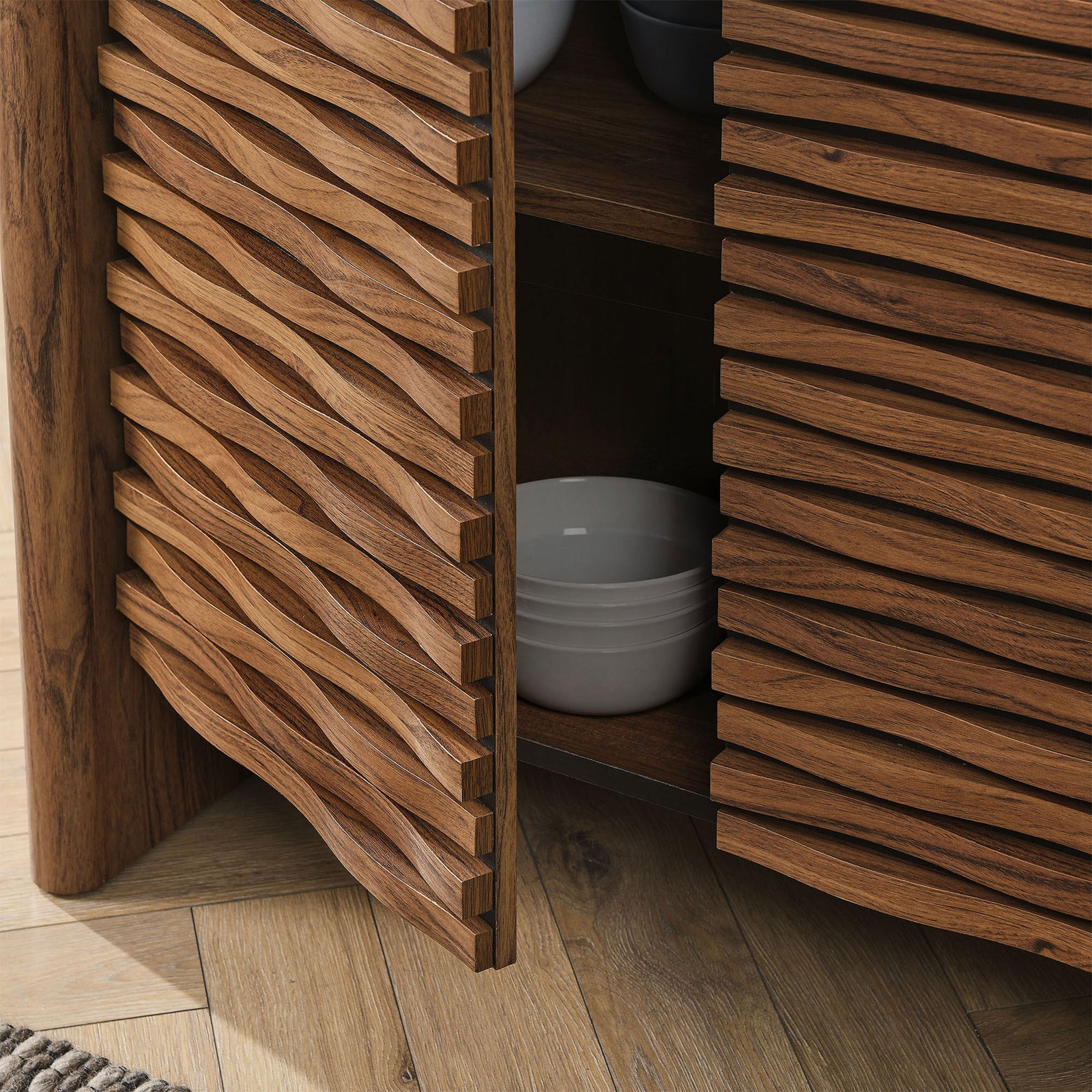 Cabinet doors open to show deep shelves storing bowls and decor against the textured wave-front design || EEI-7346-WAL || storage_open_room
