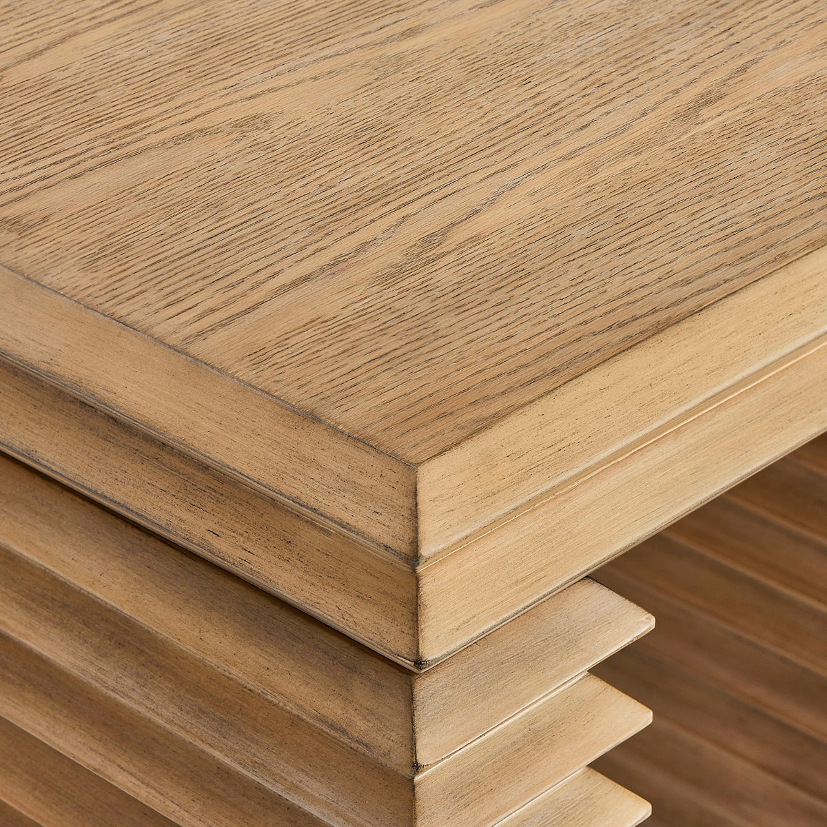 Oak veneer tabletop highlights natural wood grain, beveled edges, and the artistry of the stacked base design || EEI-7349-WOA || detail_studio