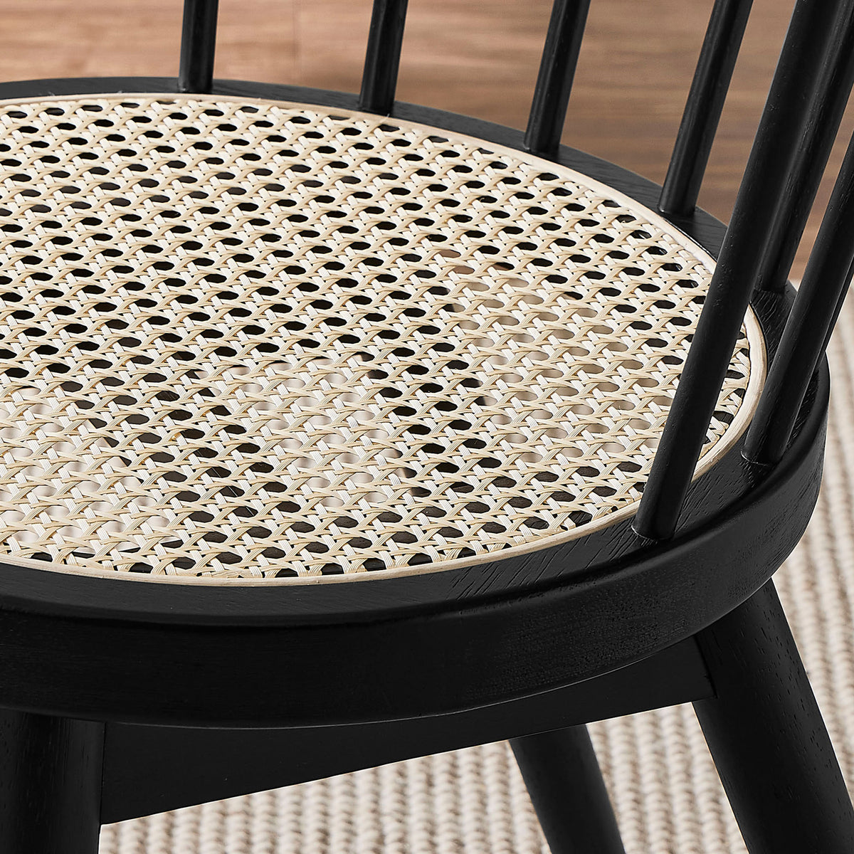 Natural cane seat pairs with soft rug and flooring to warm up the sleek black dining chair || EEI-7350-BLK || detail_room