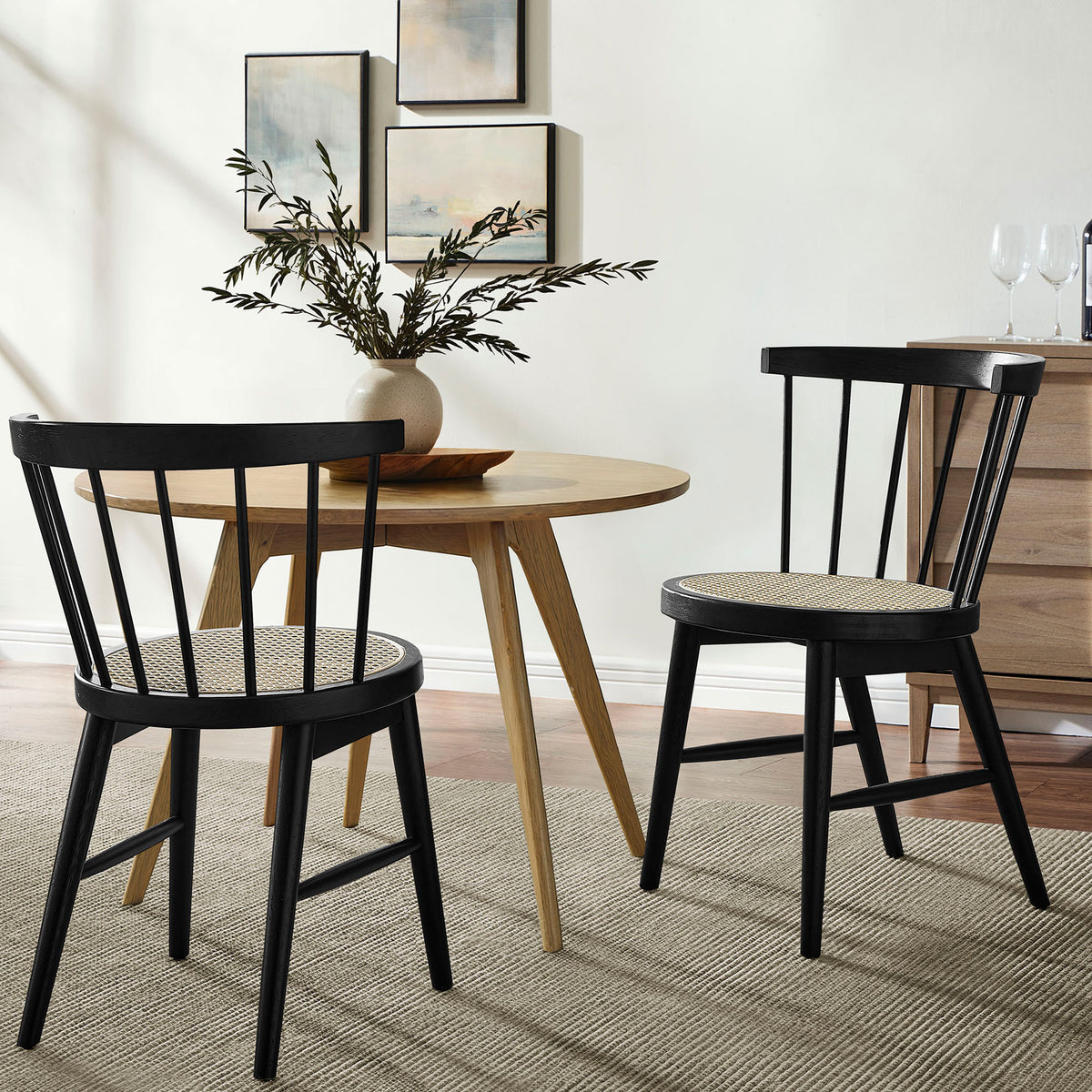 Pair of black cane seat dining chairs styled with a round wood table for a cozy modern dining nook || EEI-7350-BLK || front_angle_multi_room