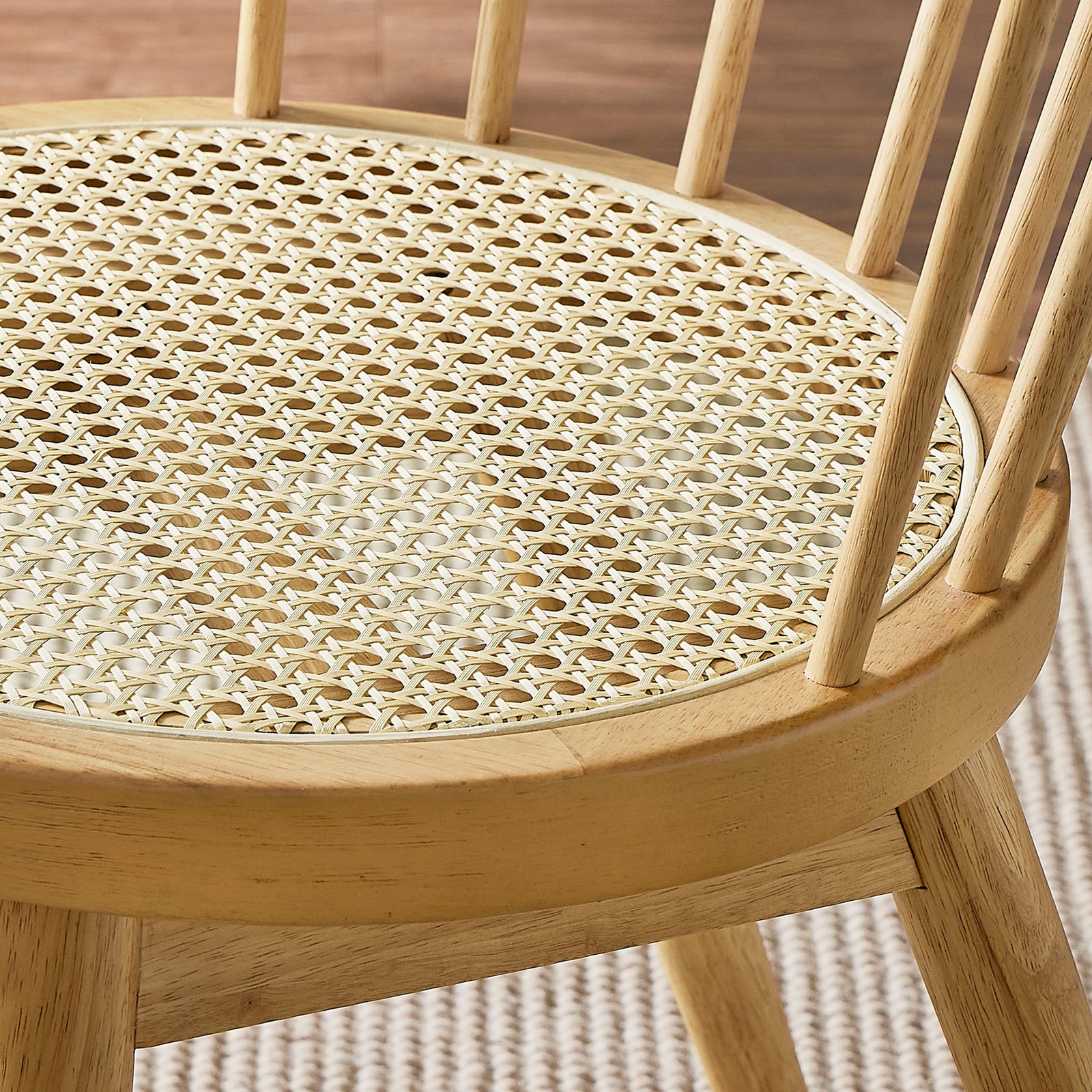 Woven cane seat pairs with warm wood tones and soft rug texture to create an inviting, relaxed dining look || EEI-7350-NAT || detail_room