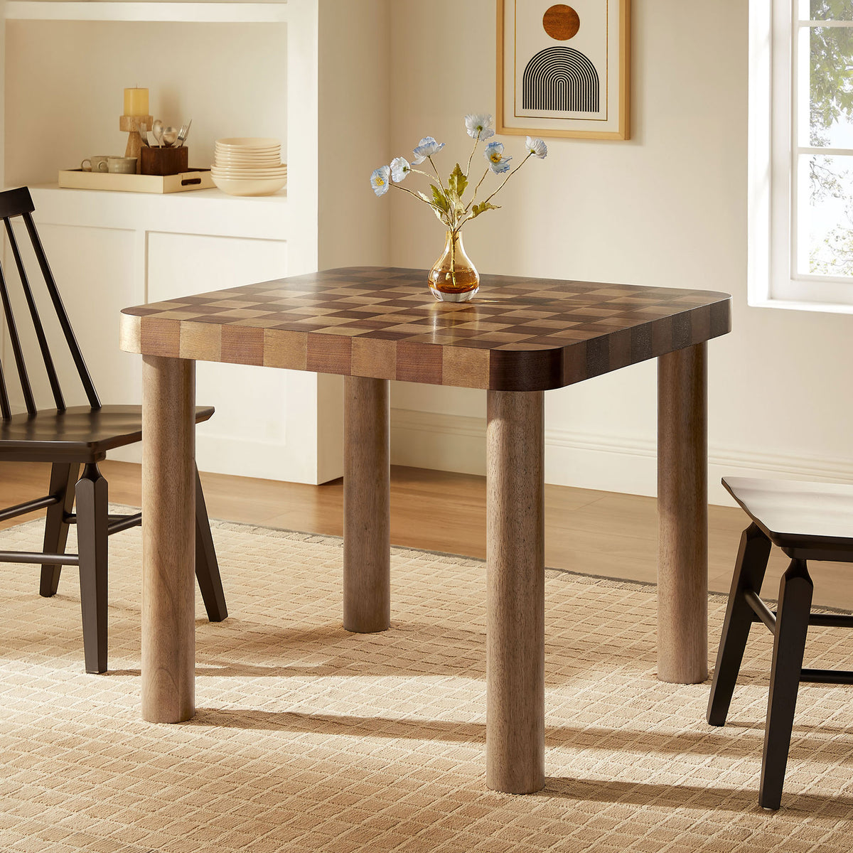 Checkered dining table styled in a bright dining nook with spindle chairs and a glass vase || EEI-7351-DWC || front_angle_room