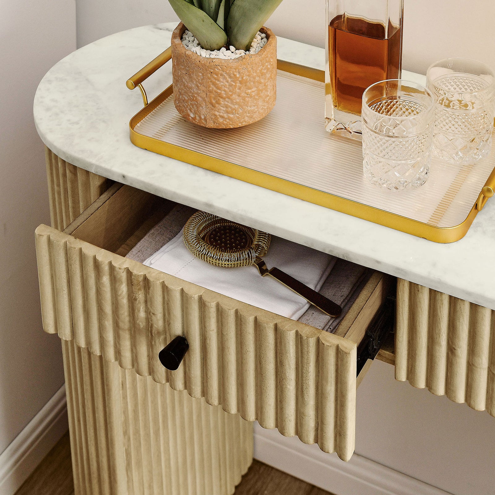 Drawer organizes small essentials while the marble top provides a chic surface for trays and decor. || EEI-7353-NAT || storage_open_room