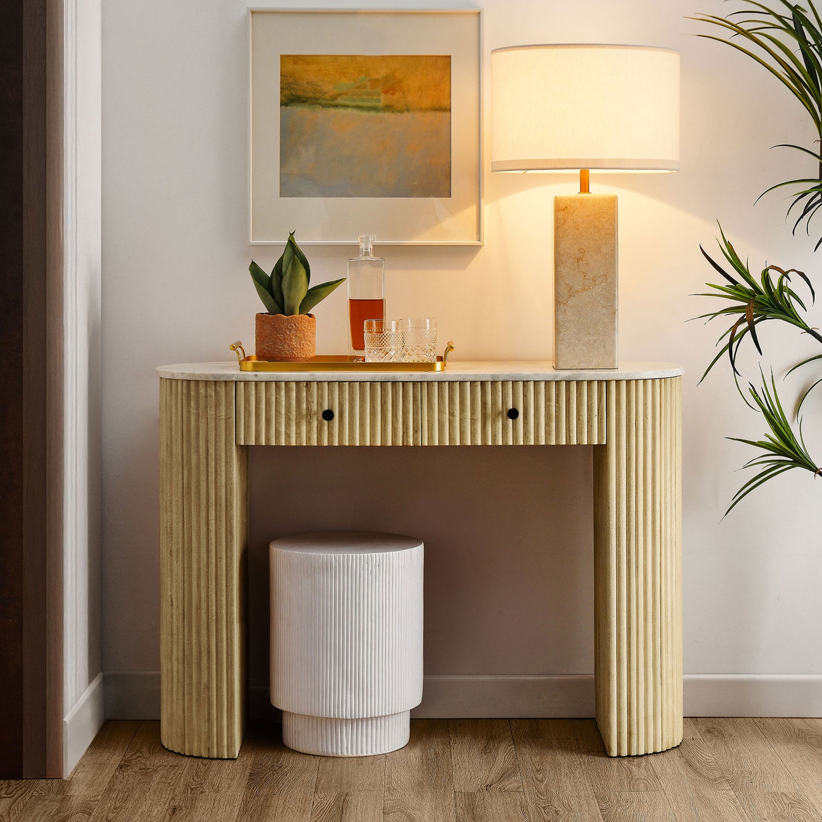 Modern console elevates your space with a veined marble top, fluted wood base, and understated silhouette. || EEI-7353-NAT || front_room