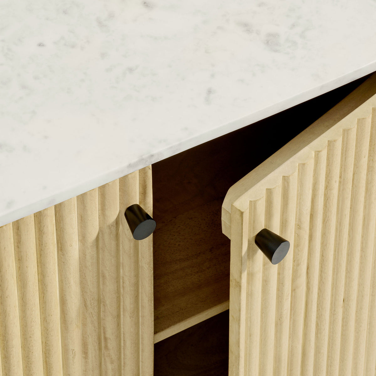 White marble top paired with vertical fluted wood door and sleek round black knob hardware || EEI-7354-NAT || handle_studio